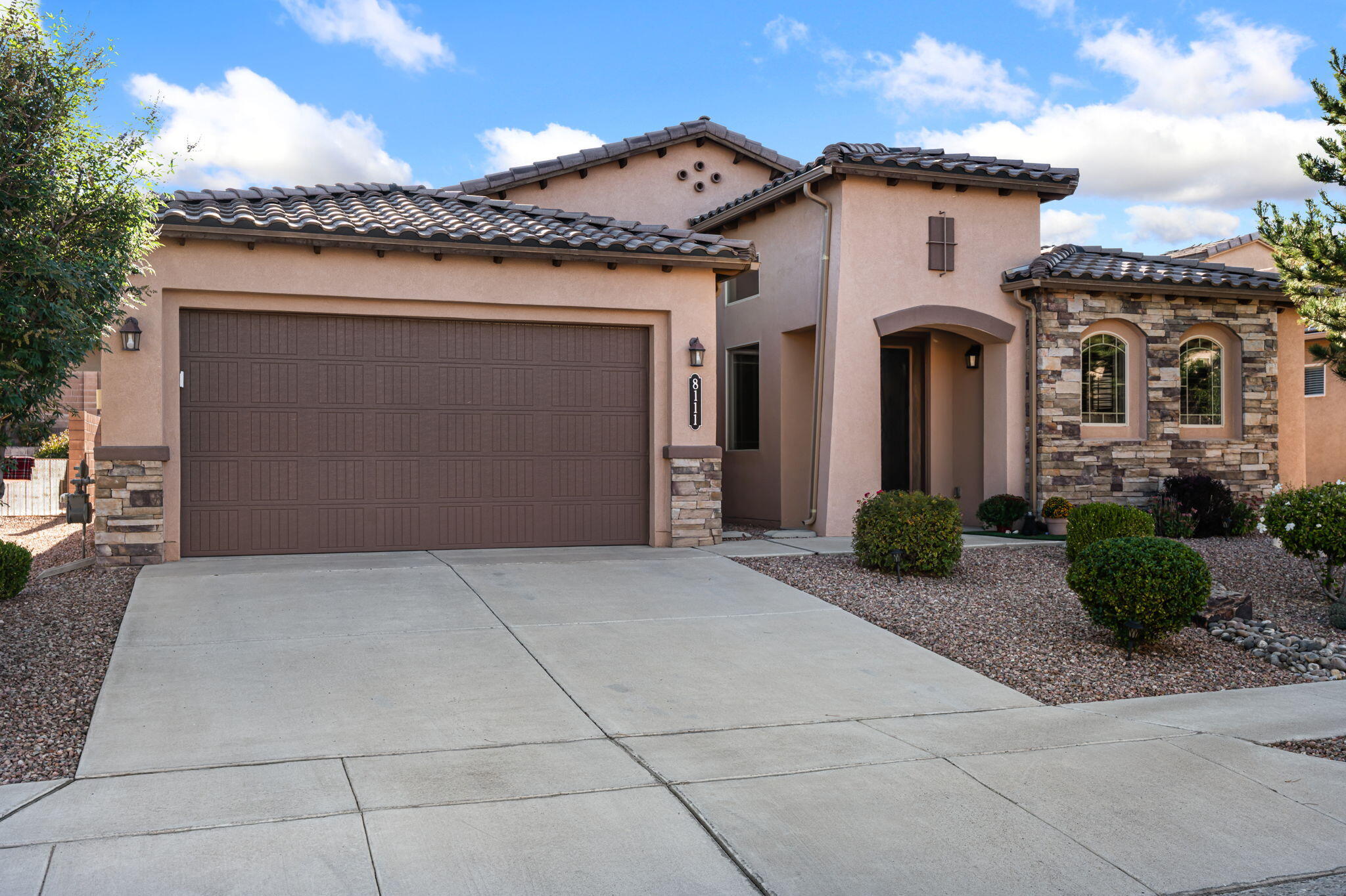 Step into this beautifully upgraded one story home with a tile roof. This home shows better than new. Plus it's Beautifully landscaped front and back for low maintenance with a large covered patio to enjoy the outdoor environment. Gorgeous custom front door leads you into this open and light floor plan. Flexible floor plan has what could be a formal living or formal dining room or a study office in addition to the 3 spacious bedrooms. A true gourmet kitchen, with granite countertops, stainless steel appliances, ample storage and a pantry. Kitchen island also can serve as a breakfast bar . This dream kitchen opens onto a large breakfast nook and lovely family room with gas log fireplace. Primary bedroom suite is separate from the other bedrooms, offering beautiful custom flooring,