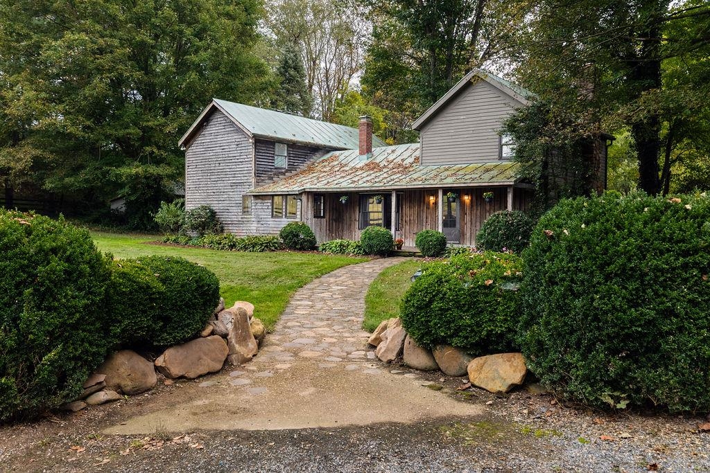A storybook escape on 5 acres in coveted TA school district! This cedar-sided beauty feels like its been pulled from the pages of a novel, offering 4  bedrooms plus bonus room, 3 full baths, and original tongue and groove hardwood floors that add warmth and character throughout. Enjoy the 20X 45 inground pool and 3-stall barn with water and electricity plus two additional outbuildings offering endless possibilities. Approximately two acres of fully fenced pasture land while the creek and additional acreage make this property a true homesteader's delight. Inside, you'll find exposed beams, original wide-plank hardwood floors, charming kitchen and unique architectural details that showcase the craftsmanship of the early 1900s. Every corner of this home tells a story, blending timeless charm with modern updates.