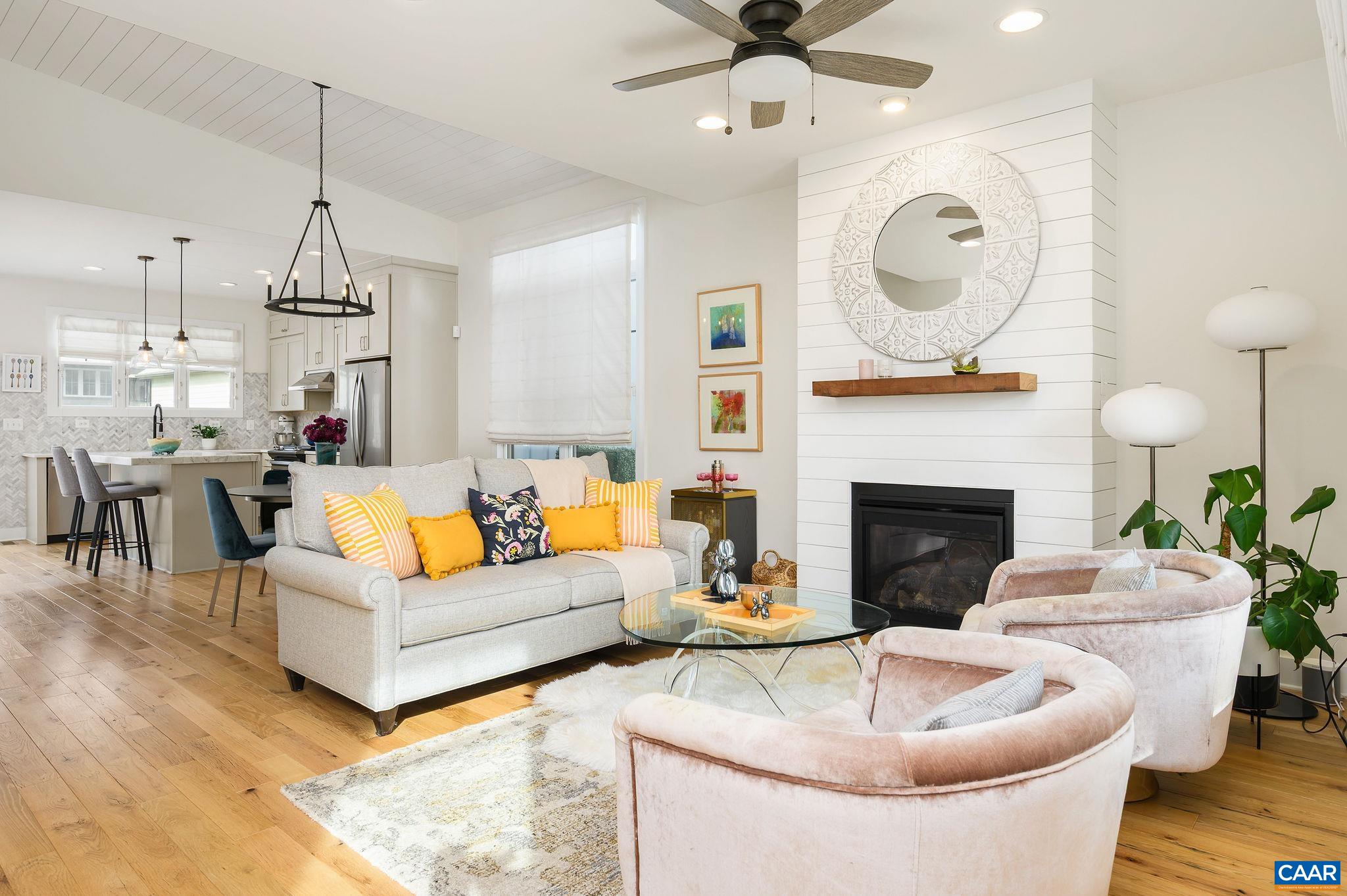 Located in Lochlyn Hill just minutes from Historic Downtown, UVA Campus and Medical Center and all area amenities, this Greenbuilt Energy Efficient home by Stony Point Design/Build offers the perfect blend of convenience and comfort. Built in 2019 and meticulously maintained, the 1,701 square foot residence is move-in ready. The main level showcases a vaulted great room with shiplap detail, reclaimed wood floors, gas fireplace and custom wood mantel, an open dining area and a designer kitchen featuring painted shaker cabinetry, marble backsplash and island. The first-floor ensuite primary bedroom provides a restful retreat, complemented by an additional bedroom that can serve as a guest room or office. Upstairs, a versatile loft/den and a private guest suite offer additional living space. A large stand-up, conditioned crawl space and exterior closet provide practical storage solutions. Energy efficiency is at the forefront with EarthCraft certification, a HERS rating and ERV system. Outdoor living is equally inviting with a charming covered front porch and rear deck, perfect for relaxing or greeting neighbors. With yard care included, this home offers low-maintenance living in a prime location.