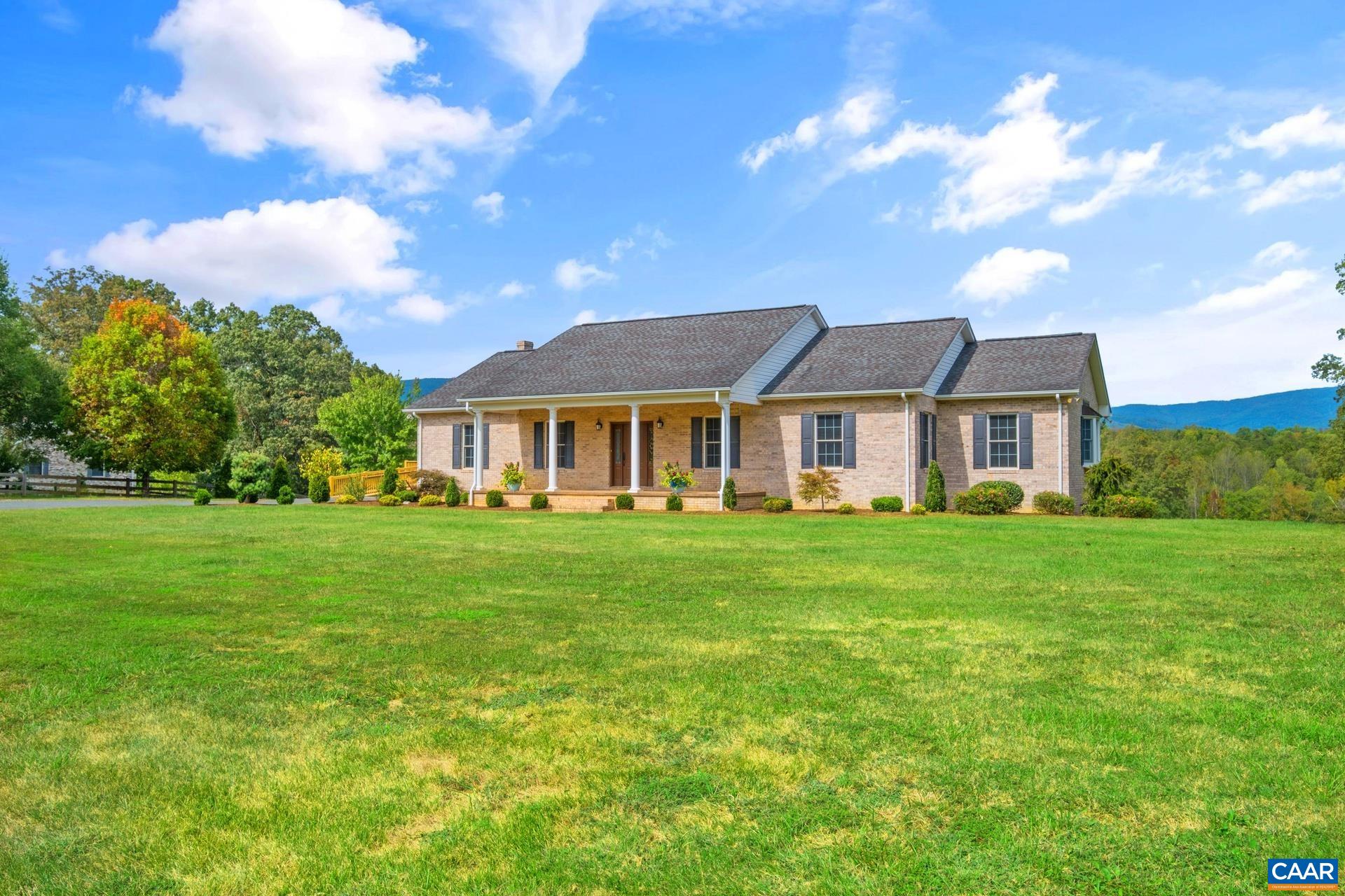 Discover this exceptional 5 bedroom, 4 bath home nestled in beautiful Albemarle County, where over 12 acres of breathtaking mountain views await. Meticulously maintained, this property offers stunning hardwood floors and a custom oak kitchen complete with a cozy breakfast nook and a generous pantry. The spacious walk-in laundry room features a utility sink for added convenience.   With two full kitchens and a terrace level entry, this home is perfect for accommodating guests or in-laws. The inviting family room features soaring cathedral ceilings adorned with wood beams, creating a warm and welcoming atmosphere throughout.   Enjoy the benefits of a detached garage with a workshop area and a reliable full house generator. Freshly painted and surrounded by mature landscaping, this home showcases incredible curb appeal. The wrap-around deck on the garage is perfect for outdoor entertaining, while the potential for a 6th bedroom, home office, or gym offers endless possibilities. Don’t miss your chance to own this versatile and beautifully appointed home!