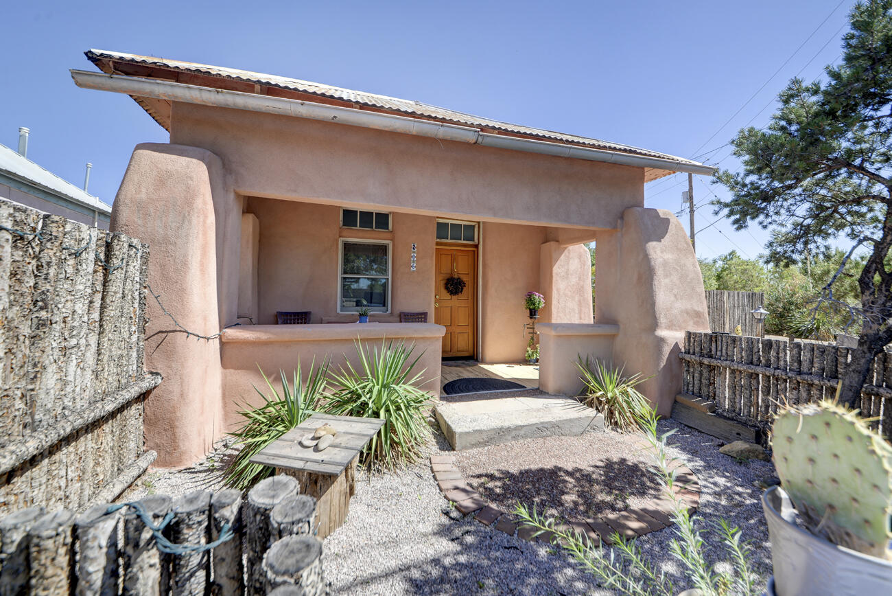 Spectacular Old Town Adobes - Two Homes on One Property! A rare opportunity to own two lovingly restored adobe homes, showcasing authentic New Mexican charm and timeless character. Each home has been thoughtfully updated with respect for the original features. The homes features thick adobe walls, wood floors, vintage light fixtures and updated kitchens and bathrooms. individual outdoor spaces. Old Town charm is everywhere you look, from the bell above the Lomas home, the ristras, vintage wagons, custom tin outdoor lights and carved tree with Our Lady of Guadalupe.Endless possibilities for live or work combinations. Currently used as successful airbnbs, but have previously been an an art studio, small private school and a jewelry shop.  Private gated entrance with ample parking.