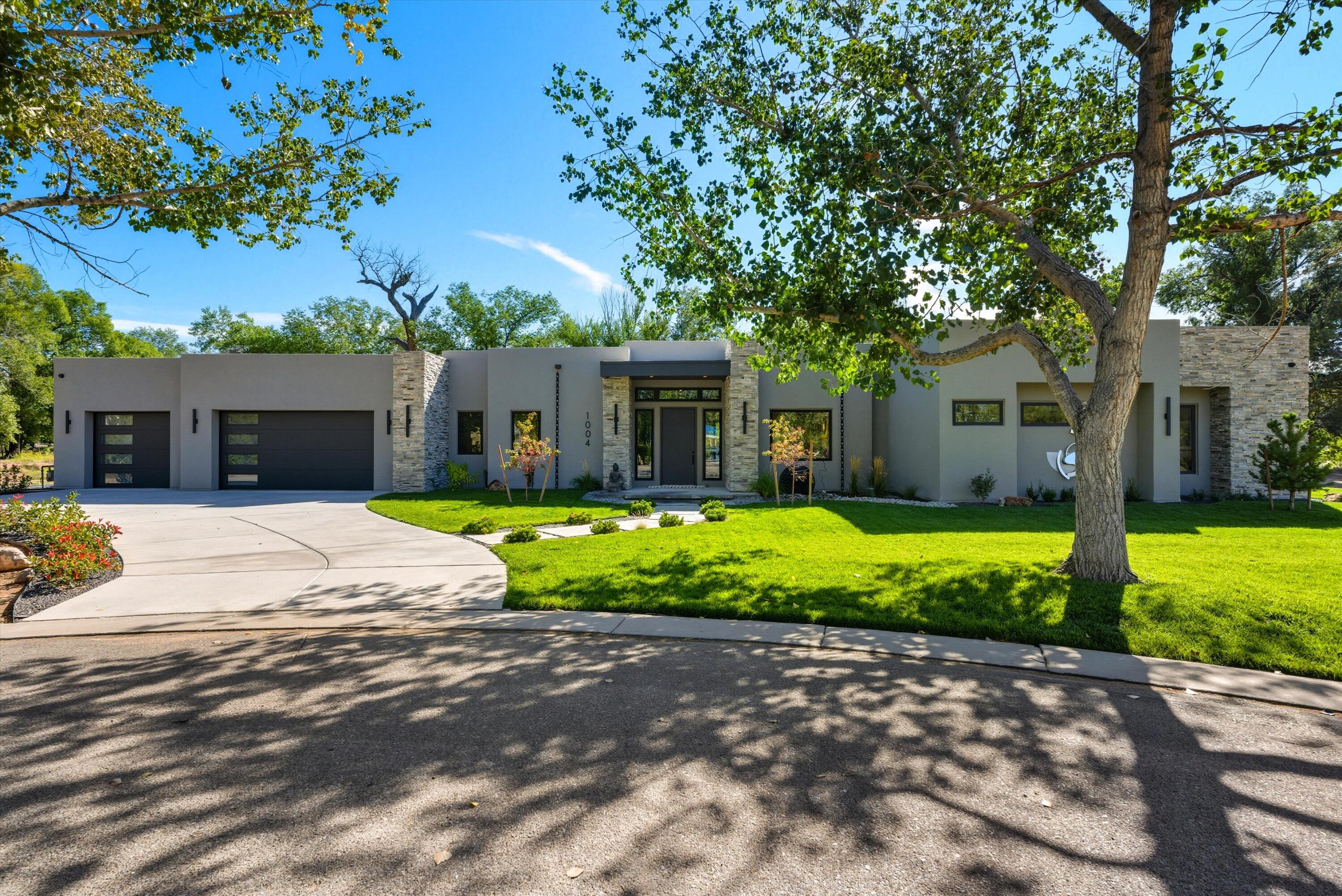 CUSTOM LUXURY LIVING IN THE PRADO COMMUNITY. This 4 bed 4 bath home spans over 4,000 sq. ft. and is tucked away on a private cud-de-sac, blending timeless design with modern comfort. Sunlight pours through windows, highlighting custom finishes, built-in bookcases, 2 fireplaces creating an inviting tone. Chef's kitchen with island, bar seating, fine cabinetry and built-ins, is adjacent to a formal dining for entertaining. Retreat to the expansive primary suite with sitting area, walk-in closet, spa shower, soaking tub. Step outside to your own oasis with a covered patio overlooking the sparkling inground pool, perfect for gatherings. Enjoy the charm of Los Ranchos, known for lush greenery, equestrian lifestyle, village feel--minutes from Albuquerque amenities.