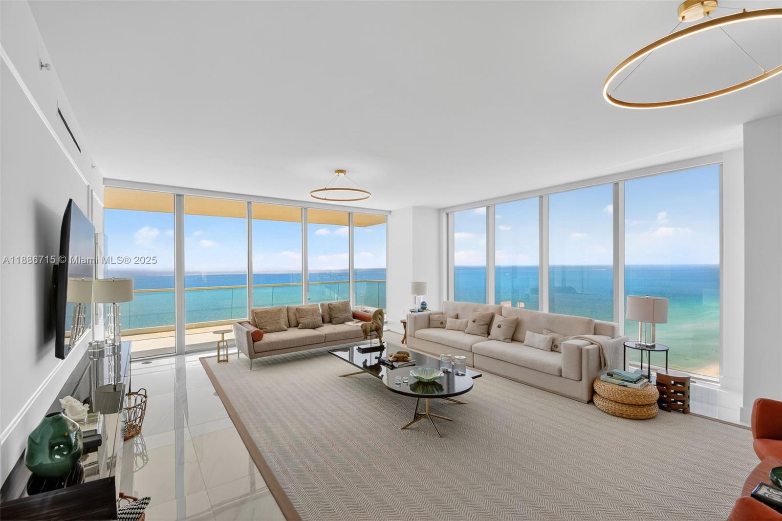 Experience unrivaled luxury in this spectacular, fully-furnished, oceanfront corner residence at Turnberry Ocean Club in Sunny Isles Beach. With 3,252 sq. ft. of living space, this home offers breathtaking panoramic views of the Atlantic Ocean, Intracoastal Waterway, and Miami skyline. A seamless open-concept design flows through the contemporary Italian kitchen and into the living and dining areas, complemented by two huge balconies. With 4 bedrooms plus den, 5.5 bathrooms and a summer kitchen in the east balcony you will have space for the entire family. Residents enjoy exclusive access to world-class amenities and services across six floors, including the extraordinary three-story Sky Club with pools, private dining, health & wellness spa, entertainment, and much more!
