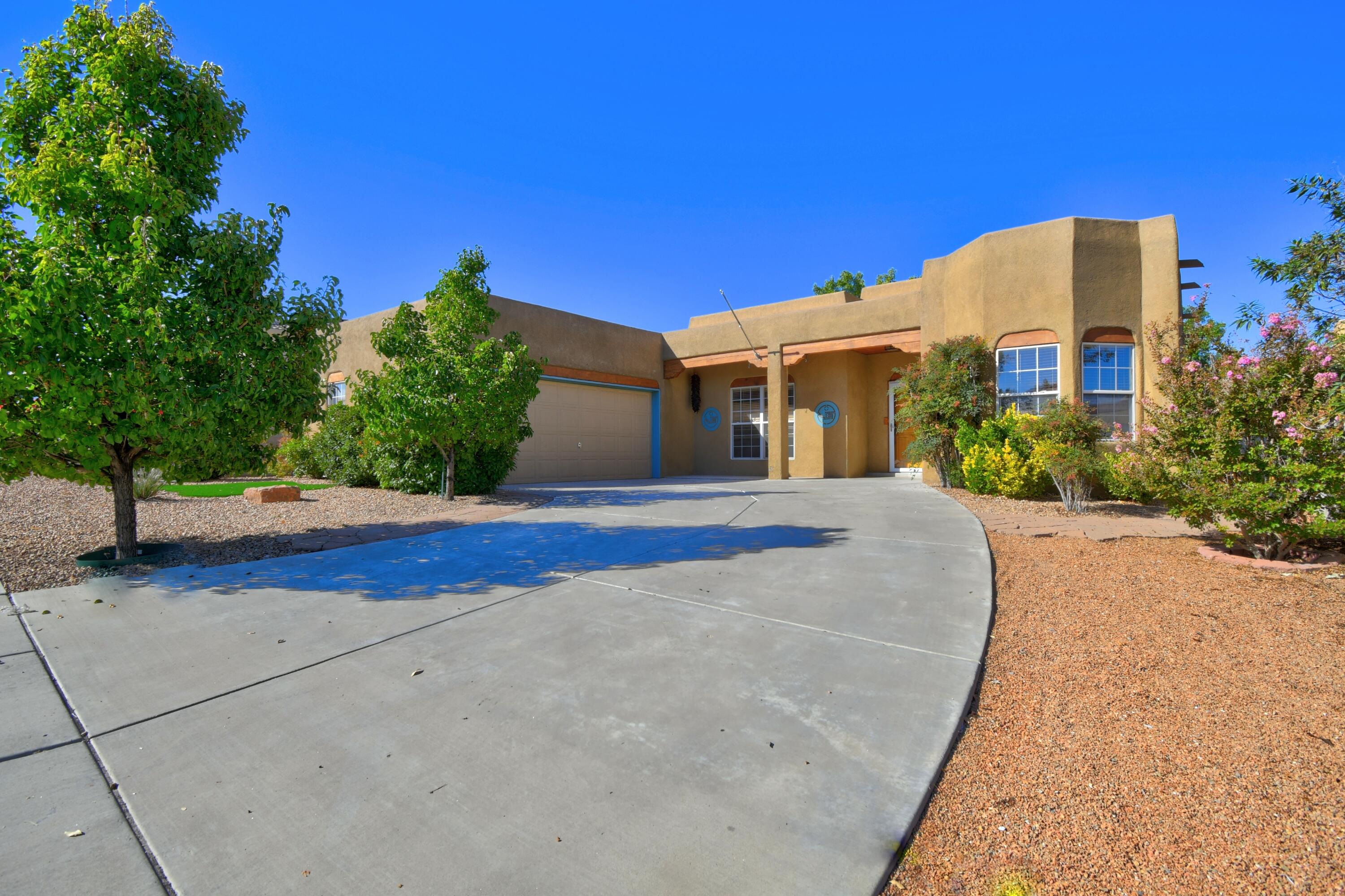Pride of ownership shines in this stunning home featuring 3 beds and 2 full baths, a versatile office with private side access, perfect as a 4th bedroom or guest suite. Enjoy paid-off solar panels and a TPO roof under 3 years old. Inside boasts wood flooring throughout, bathrooms have custom waterproof vinyl flooring, and a gorgeous walk-in shower in the primary suite. Granite kitchen countertops, a breakfast nook and dining area open to a spacious living room, ideal for entertaining. Step out back to breathtaking New Mexico sunsets with a private backyard with low-maintenance landscaping, a view of the coveted Petroglyph national monument, nearby hiking trails, biking, and parks. Large driveway, and a two car attached garage.  Efficiency, elegance, and location, don't miss out!