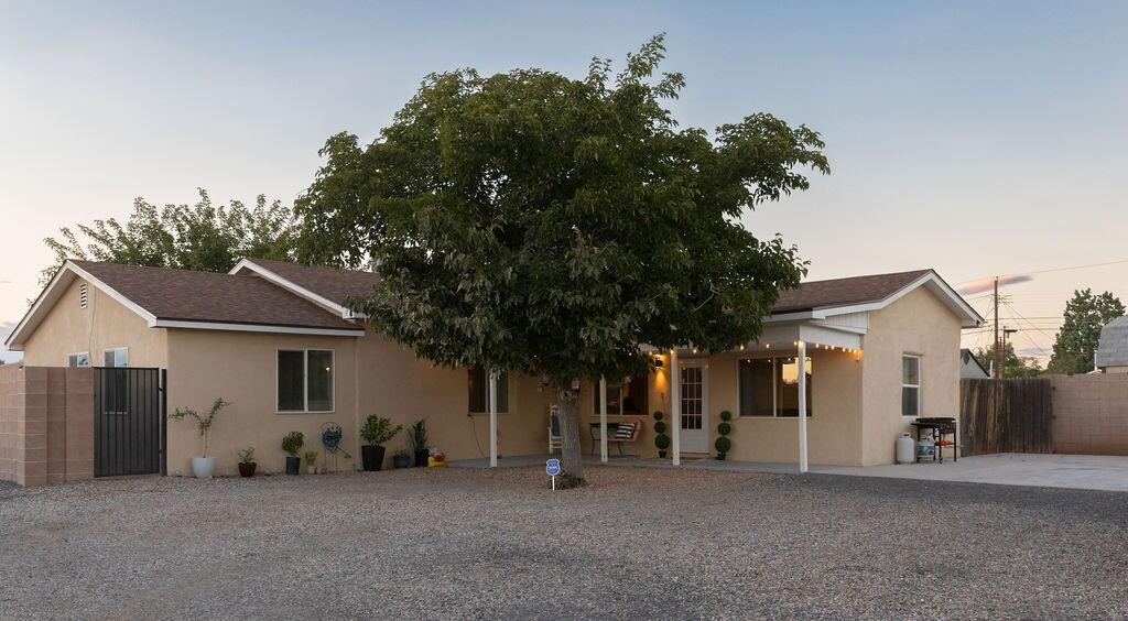 Welcome to the vibrant North Valley, where timeless charm meets modern living in this beautifully updated 3-bedroom, 2-bath adobe home. From the moment you arrive, the meticulous care and craftsmanship are evident--from the newer roof and fresh stucco to the crisp interior paint completed in 2024, all contributing to a clean, contemporary feel while honoring the home's traditional roots.Inside, the home flows seamlessly from the adobe kitchen, featuring original wood vigas, to the living room designed for comfort and style. The kitchen is a functional showpiece with granite countertops, stainless steel appliances, and large-format tile flooring that adds a sleek, modern touch. The character-filled bedrooms are bright and airy, boasting upgraded bathrooms for easy, comfortable living.