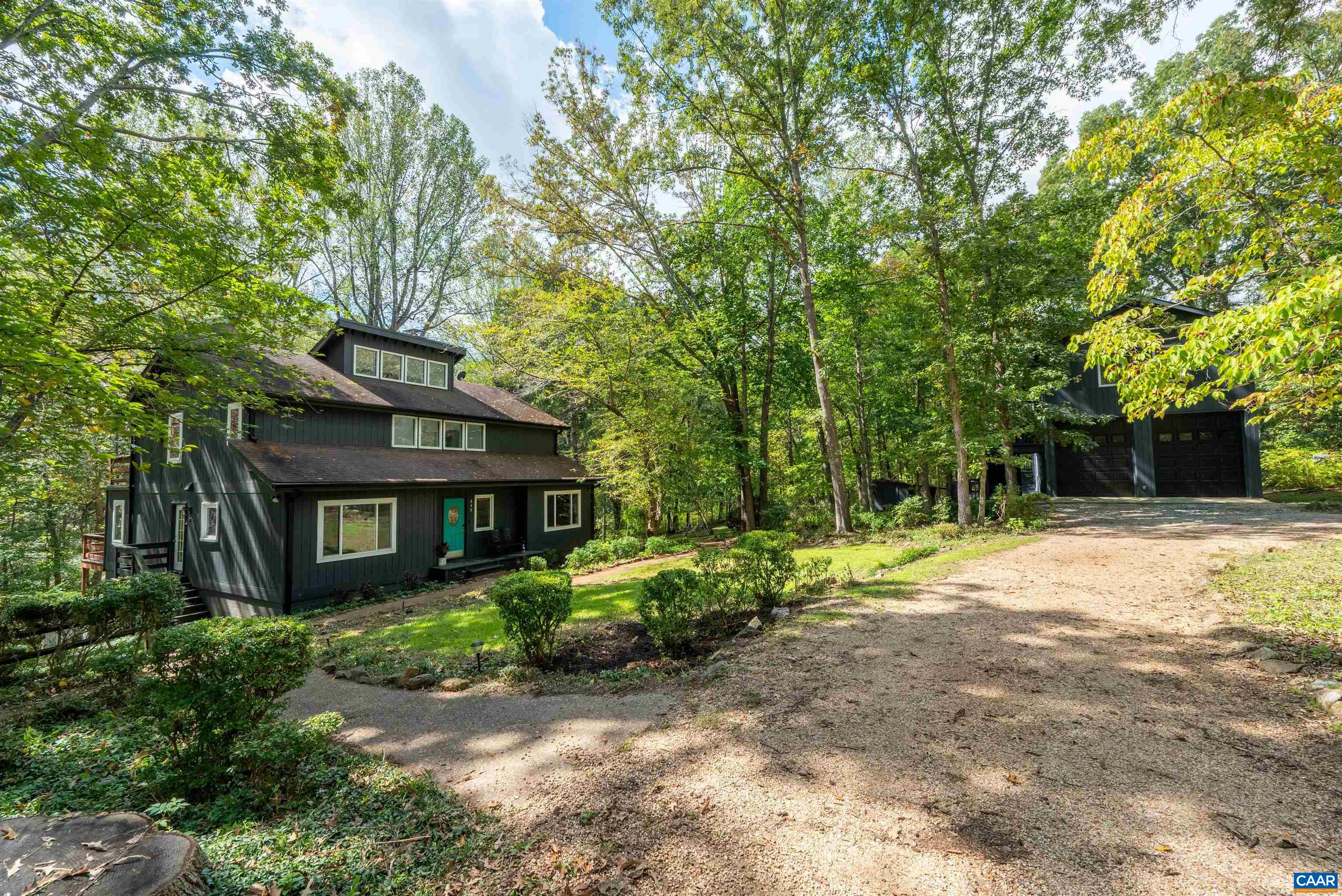 Tucked away on 5.82 private acres in Ivy, this four-bedroom, two and half-bath home offers a serene retreat surrounded by woods and a picturesque stream. The property features an oversized detached garage(space for 3 cars) with workshop and a one-bedroom apartment, providing ample storage and potential for rental income or a guest suite. The contemporary home boasts cathedral ceilings, a spacious back deck with scenic views, and a 1,500 sq. ft. unfinished basement with a wood stove and rough plumbing for a full bath, offering potential for storage, a workshop, or future finishing. Cozy up by the wood-burning, two-sided fireplace in the living room during winter. The primary suite includes a private balcony, and the home and garage apt. is equipped with high-speed fiber optic internet(1gb) for remote work. The expansive lot provides 4+/- acres of wooded area for kids and pets to enjoy, with trails, treehouses, and endless opportunities for adventure! A backup generator ensures uninterrupted power. Located in the desirable Western Albemarle School District, this home offers the added convenience of being less than 2.5 miles from the interstate & just a 15-minute drive to Charlottesville city & UVA. Open house this Sun 2nd, 2:30-4!