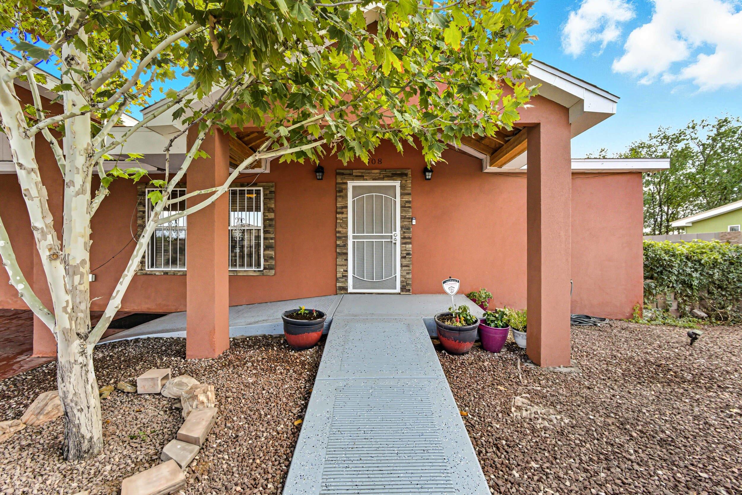 This 1,595 sq ft home offers 4 bedrooms and 2 baths with tile flooring throughout for easy care and style. The kitchen features granite countertops, a breakfast bar, and plenty of space for gathering. The primary suite includes a walk-in closet, while outside you'll find an entertainer's dream with a built-in outdoor kitchen complete with grill, mini fridge, and double oven. Enjoy relaxing on the covered back patio overlooking turf grass, perfect for low-maintenance living. Additional highlights include a covered carport, storage sheds, full fencing with backyard access, and thoughtful details that make this home move-in ready.