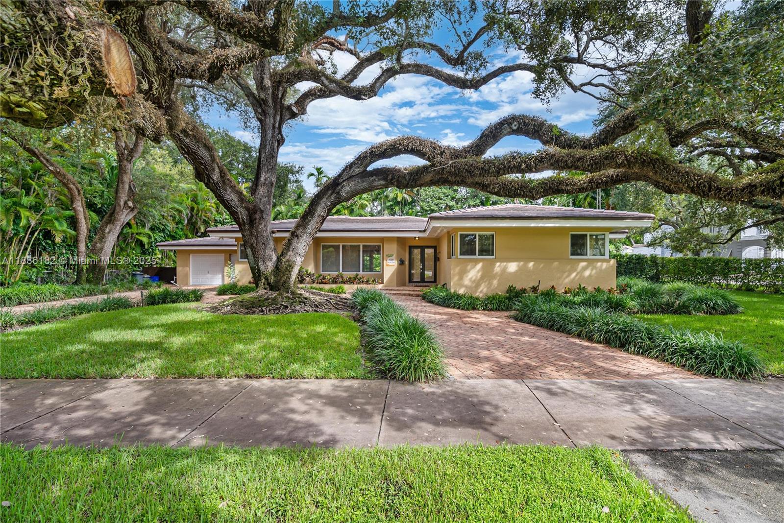 Spacious and comfortable South Gables home with dramatic live oak welcoming guests. Terrific floor plan - spacious 3 bedroom + den, 2 bathrooms, 2,830 sqft. Features an open living room, dining room and very large Florida room. Lovely finishes include crown moldings, recessed lights, and French doors. The eat-in kitchen and bathrooms have been remodeled with marble, wood cabinets & granite. Home has impact windows and rolladen shutters for FL room. 2 car garage with laundry, sink, and gardener bathroom. This home sits on a massive 15,000 sq. ft. lot. The lush, private yard has a covered patio with Chicago brick walkways and plenty of grass for kids to play around on.