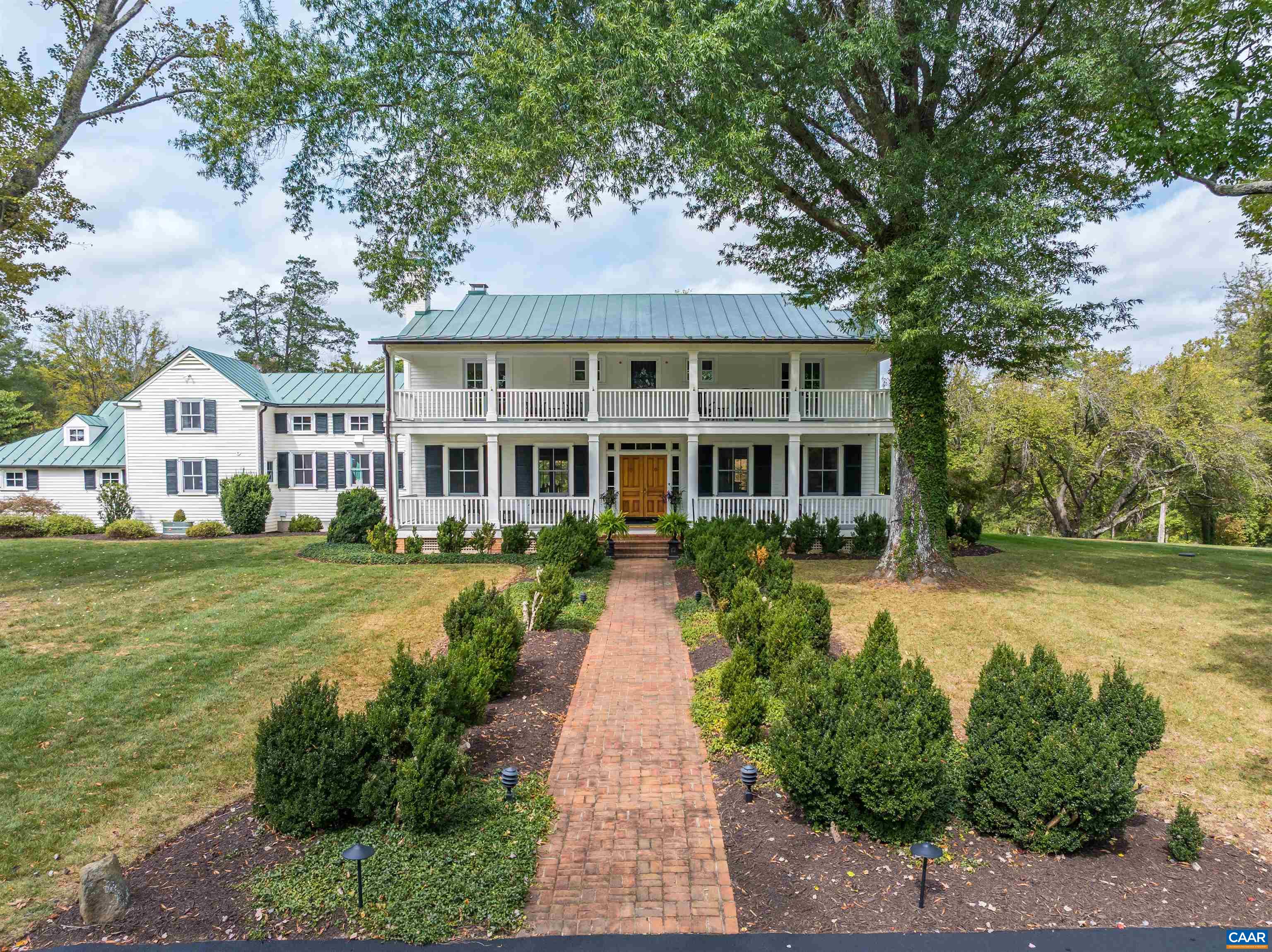 This luxury home is now available in Keswick! Originally built in 1850, 5484 Gordonsville Road was renovated in its entirety in 2019. At the center of the home is a gourmet kitchen designed for culinary enthusiasts and those who love to host. Complementing the kitchen is a regal dining room, pub, and living room. The primary bedroom boasts a walk-in closet and large bathroom. The second floor also offers two additional bedrooms, each with a full bath and balcony access. The garage with an EV charger and custom-built barn doors completes the design. Behind the home is a patio ideal for quiet evenings. Relax by the fire pit overlooking a private swimming pool and garden. The guest cottage offers two bedrooms, a full bath, and a kitchen. The property’s 55 acres are bordered by conservation easements yet remain unencumbered themselves. With five division rights, the possibilities for future use are nearly infinite. Located 20 minutes from Charlottesville, this property is down the road from Keswick Hall and is a short drive from the region's finest wineries. Here, you'll find the perfect balance of privacy and connection, an invitation to live beautifully in Virginia's countryside.