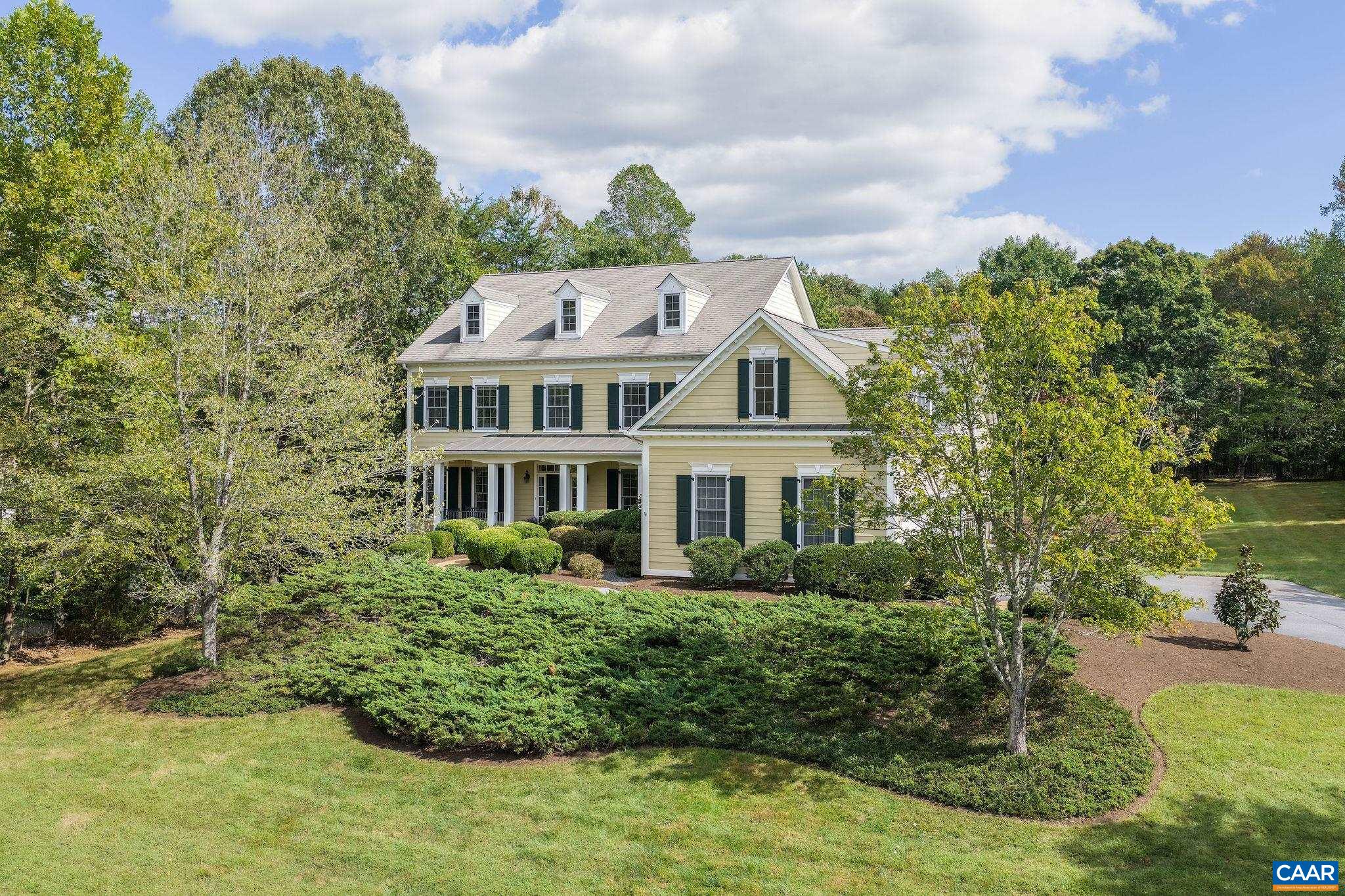 Discover the art of gracious living—from natural light to flow and proportion—in this 5 bedroom, 6 1/2 bath home in the gated community of Walnut Hill. This tree-lined enclave offers unbeatable convenience, just 5 mins to CHO Airport, 15 to UVA, 20 to downtown CVille, and ideally situated on the DC side of Albemarle Co. for commuters. Inside, every space speaks of craftsmanship and warmth, with formal living and dining rooms for hosting memorable gatherings. The family room, anchored by a stunning stone fireplace, flows effortlessly to the kitchen & breakfast room, where wooded views create a peaceful backdrop to daily life. The primary suite upstairs is a retreat, with a private sitting room and a serene bath. Two addl bedrooms with ensuite baths + 37x16 bonus room provide endless possibilities for remote work, creative pursuits, or playroom. A first-floor guest suite provides versatility for multi-generational living or visiting friends.The walk-out terrace level includes a rec area, 5th BR, new full bath and abundant storage. Enjoy leisurely walks along paved trails, afternoon tennis matches, and evenings by the community pool—all just minutes from the cultural and culinary treasures of Charlottesville.