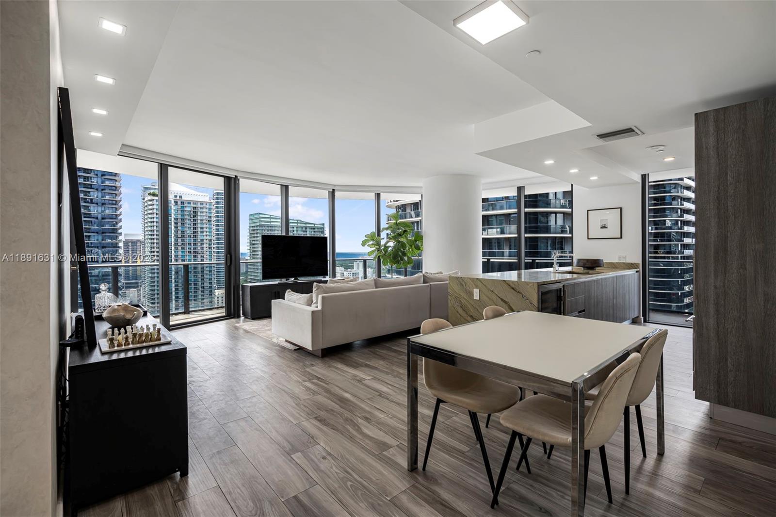 Stunning corner residence in one of Brickell’s most exclusive towers & steps from Brickell City Centre. This coveted 01 line unit features 3-bedrooms, 4-bathrooms, as well as a private elevator that opens to a dedicated foyer, floor-to-ceiling windows framing dramatic city & bay views, and a wraparound balcony connecting all rooms. This is the only unit in the SLS Lux with an expanded primary suite and a closed-off den/laundry room. Also includes rare attached storage, and 3 total parking spaces (two assigned parking spaces - no lift + one valet). Every detail exudes luxury—developer upgrades, WOLF appliances, marble counters, wine cooler, motorized blinds, smart lighting (with voice controls). Impeccably maintained by its owners, never rented—a true masterpiece for the best price.