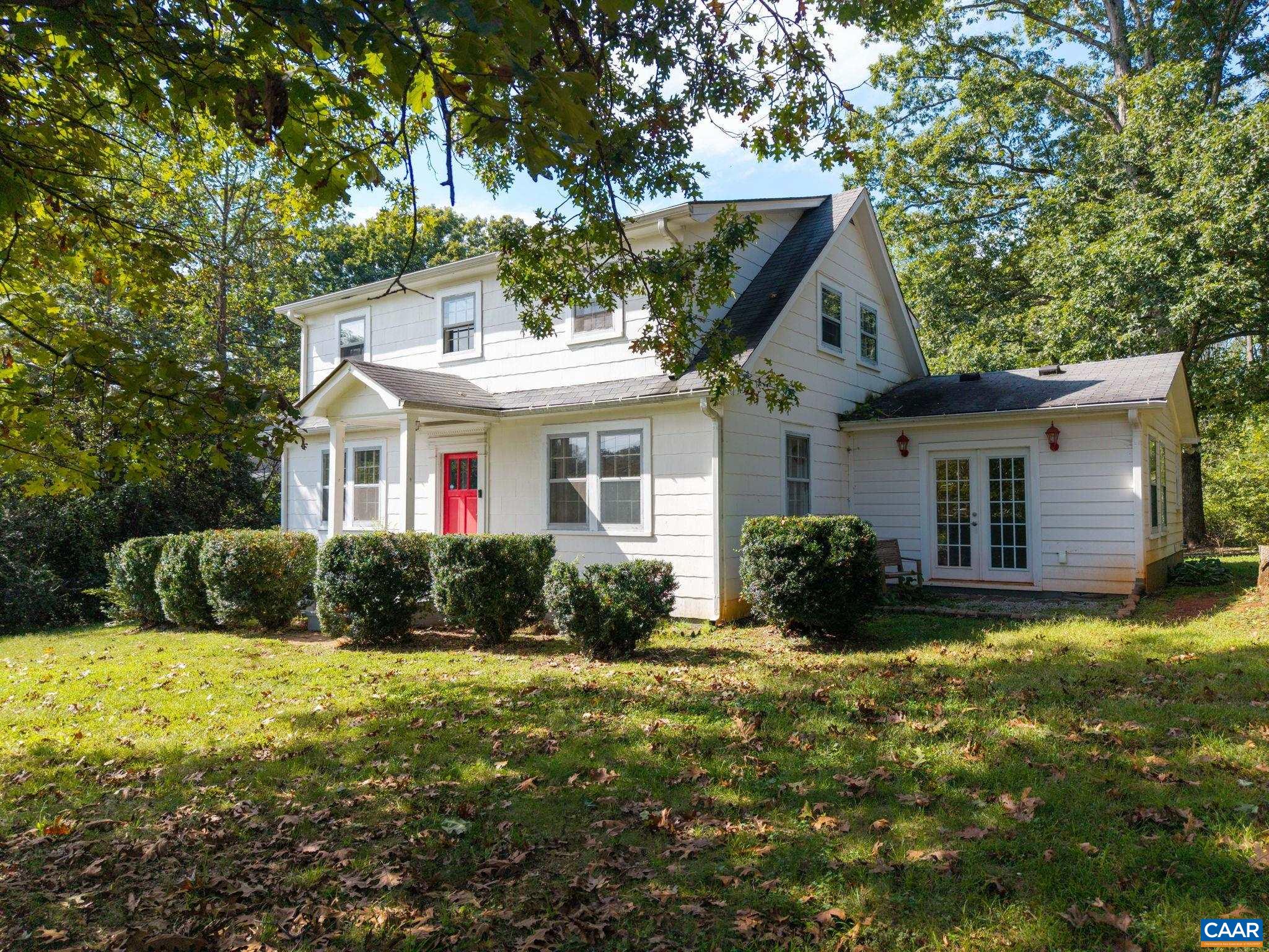 This adorable 1940's abode is ready for its next chapter! Less than 10 minutes from UVA's Fontaine Research Park, just 2 minutes from Dr Ho's, and within walking distance of Red Hill Elementary, this four bedroom gem has everything you need... large front and back yards, a circular driveway with enormous two-car garage, and spacious rooms for living your best life. Main level features living room, dining area, kitchen, half bath, large family room with vaulted ceiling, fireplace, and access to back patio, a mudroom with sink and laundry, and the primary bedroom accessed through the primary bathroom or it's own patio entrance. On the home's second level are located three additional bedrooms with hardwood floors and a second full bathroom. Boxwoods, mature oaks, and even blueberries landscape level yards perfect for entertaining. Charm, character, and convenience abound!