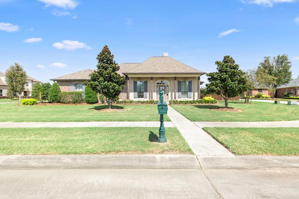 Discover refined living in Ashton Plantation Estates. Located within the top-rated St. Charles Parish School System just minutes from I-310. This one-story home offers 10- and 11-foot ceilings, a thoughtful open layout, and beautiful design details throughout.
Step inside to find a bright foyer leading to a formal dining room, currently used as a cozy sitting area, perfect for relaxing or entertaining. From there you will find a bedroom and full bath behind a pocket door for added privacy. Continue into the spacious living room, featuring recessed lighting, a brick gas fireplace, and built-in bookshelves, creating a warm and inviting atmosphere. The 16x13 primary suite sits privately off the living area and showcases an 11ft tray ceiling, a luxurious bath, his and her sinks, soaking tub, walk-in tile shower, and a large walk-in closet with plenty of space.
The kitchen is a true centerpiece, boasting granite counters, stainless steel appliances, a large island with added seating, gas over, plenty of cabinet space, and a walk-in pantry. The kitchen seamlessly connects to the living and dining areas, making it perfect for gatherings. From there, you will find two additional bedrooms on the opposite side of  the primary bedroom connected by a Jack and Jill bathroom with double granite vanities.
Step outside through double doors to a covered patio with an outdoor kitchen, mounted TV setup, and rear yard access—ideal for entertaining or relaxing.
Additional highlights include a tankless hot water heater, security system wiring, attic access in the garage, and an electric garage. The roof was replaced after Hurricane Ida, offering peace of mind for years to come.
Stylish, functional, and perfectly located, this Ashton Plantation Estates home delivers comfort and charm in one of Luling’s most sought-after neighborhoods!
Legal Dimensions read as follows: 61.56+23.55+40.95/107.39x99.25/101.15