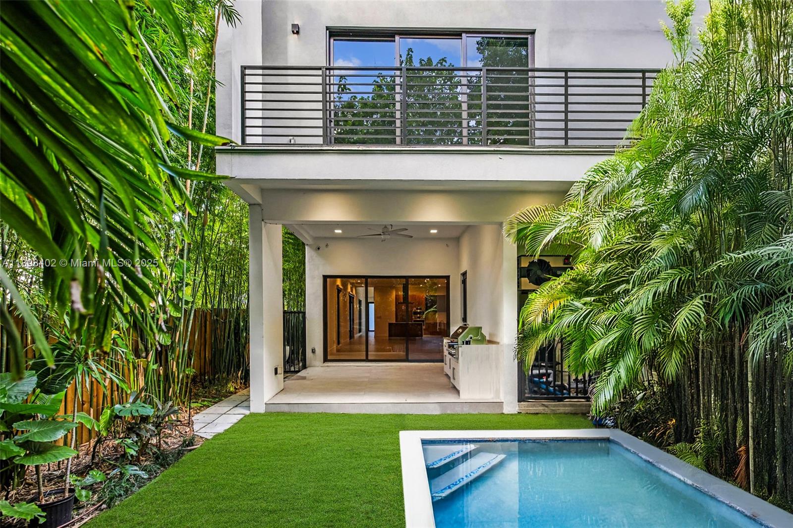 Experience the best of Coconut Grove living in this modern 4-bedroom, 5-bath luxury single-family home, built in 2022 for effortless indoor-outdoor living. Behind a private gate, it offers open spaces, floor-to-ceiling impact glass, and refined designer finishes throughout. The gourmet kitchen showcases Italian Pedini cabinetry, Bosch appliances, and quartz countertops. The layout includes a floating staircase, sleek spa-like baths, and two A/C units. Step outside to a private pool, summer kitchen, and lush tropical landscaping. Ideally located on a quiet tree-lined street near top-rated schools, parks, restaurants, and marinas. Two-car garage, smart-home technology, and electric blinds complete this exceptional residence.