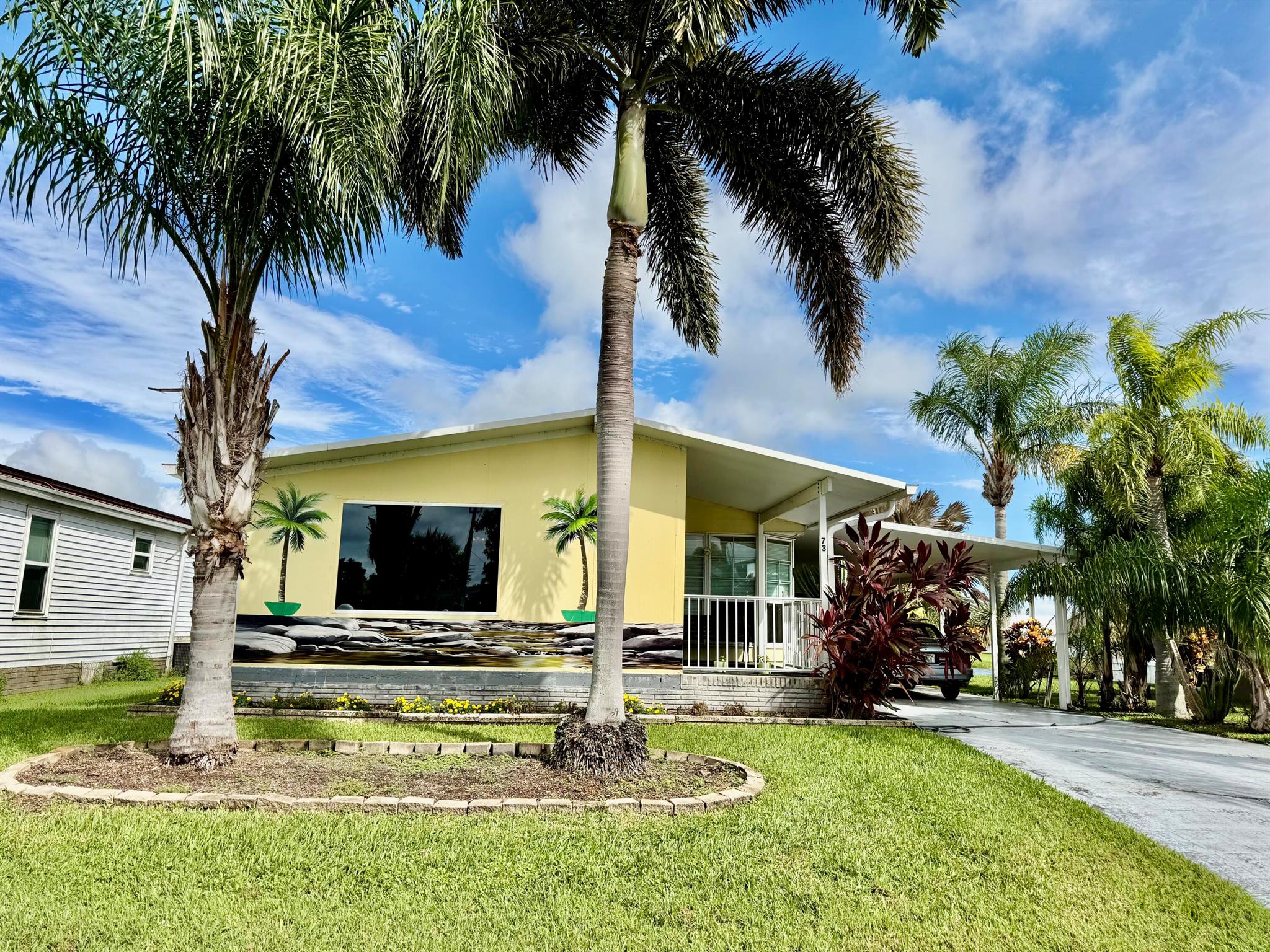 OASIS VILLAGE~ Best Location! Only steps from the clubhouse/ pool and activities! 2 Bd/ 2 Ba/ Carport AND 14x21 workshop/ garage. Beautiful curb appeal.  Front Florida room with panoramic view! Out back -10x 25 Sitting room with gracious view of the community lake. Formal living and dining room with bay window. This one has so much potential! Create your masterpiece! 1822 Sf under air - 3220 TLA. 14x50 carport and drive way. Fish from your own dock...remember if you catch Harvey, be kind and set him free! LOCATION~LOCATION!Dimensions are approximate, must measure for exact