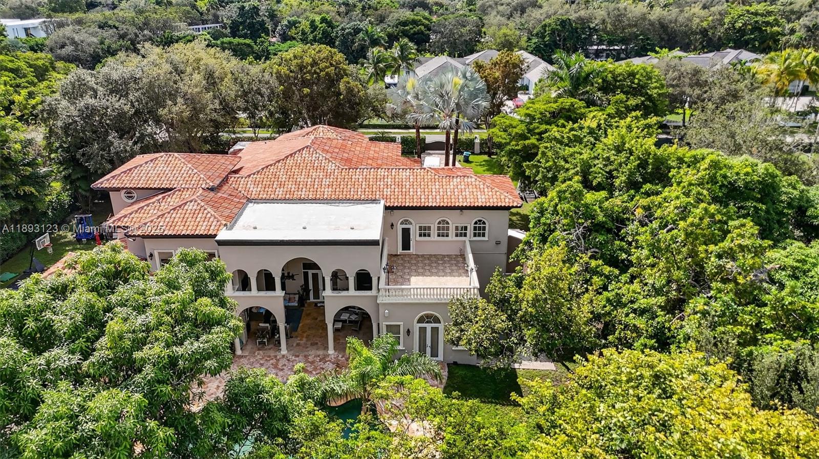 Timeless Elegance in Pinecrest.  This stately 6-bed, 9-bath estate offers luxury and privacy on a lush builder’s acre lot. Features include a maid’s quarters and in-law suite with private access, expansive living areas, family room, theater, and safe room. Enjoy a 5-car garage, guest parking, and an expansive travertine driveway. Outdoor amenities include multiple patios, a basketball court, waterfall pool, and summer kitchen. The chef’s kitchen boasts multiple ovens, sinks, and dishwashers. Gated entry, camera surveillance, surround sound, and a whole-house generator ensure security. Once the set of the Iconic Charlie’s Angels TV Series, this home blends Hollywood glamour with modern sophistication.
