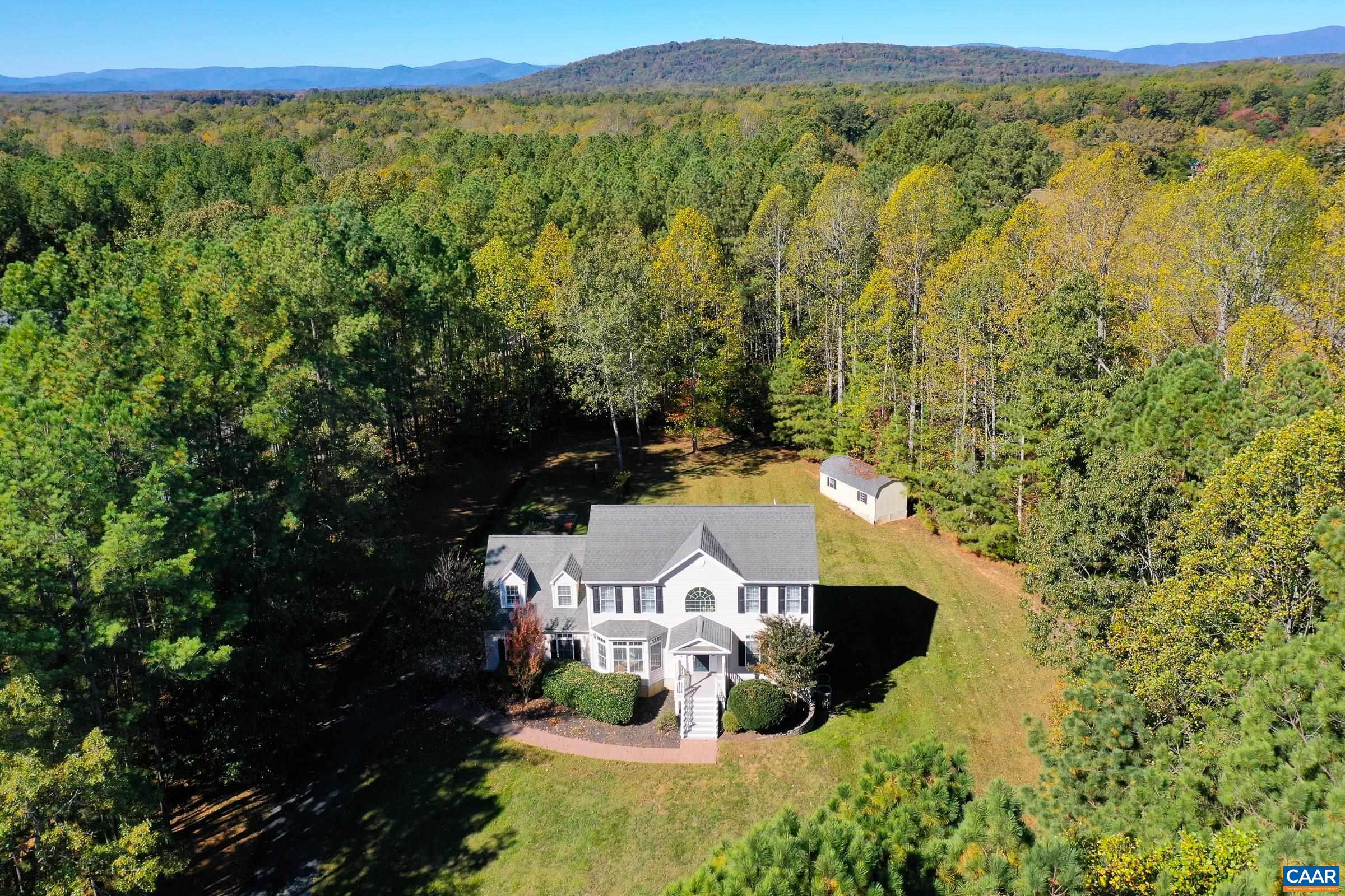 Wow! Secluded home on 2.4 acres in Albemarle County feels like a private escape yet is minutes from route 29 shops and restaurants. Walk to Preddy Creek Park! This four bedroom four bathroom home features hardwood floors throughout the main level that sparkle in the light-filled rooms and upgraded berber carpeting in the bedrooms and basement. The gourmet kitchen features maple cabinets, granite counters, and stainless steel appliances. The rear of the home features an open floor plan with great room boasting a gas fireplace with stone surround. Formal dining room offset by arched doorway is great for hosting too! A home office/study at the front of the home features french doors for privacy and could also be a guest bedroom with main level full bathroom. Upstairs the primary suite features a private bath with jetted soaking tub, separate shower, dual sink vanity and walk in closet. Two additional bedrooms and a bonus room/fourth bedroom share large hall bathroom. Walk out lower level features a large rec room with future wet bar area, a den/storage area, full bath and media/play room.  All this plus a large composite deck, patio, garden area, 12'x24' shed, and two car garage! You must see this!