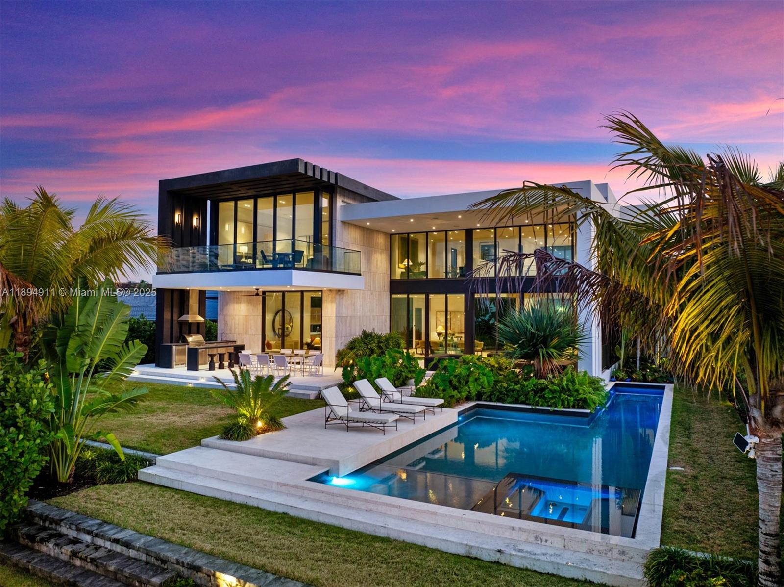 Your brand-new tropical modern home awaits in Golden Isles. Designed by SDH Studio Architecture and built by TREO Construction, this masterpiece spans over 8,000 sq. ft. of total area and sits on a 12,750 sq. ft. lot. It offers soaring ceilings, five spacious bedrooms, an office, and service quarters. The top-of-the-line Italian kitchen is a true showpiece, complemented by a well-equipped wine cellar. The expansive backyard features a lap pool, jacuzzi, and covered terrace—perfect for entertaining. With 85 feet of private waterfront, the home is fully equipped for boating, offering breathtaking views. Ideally located in a prime position, just a short walk from the main entrance and parks, this residence embodies luxury waterfront living at its finest—a true oasis of elegance and comfort.