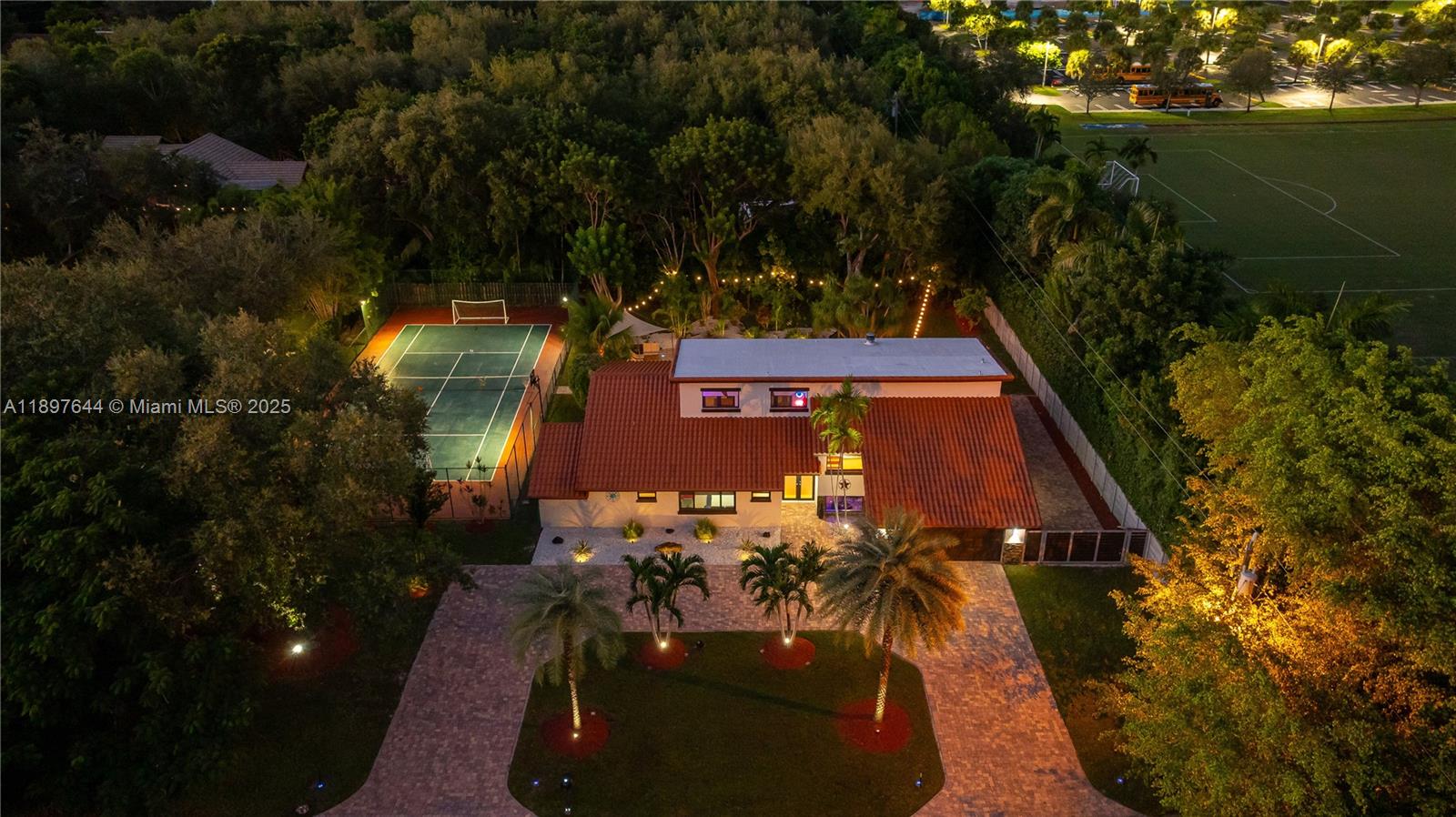 Escape to your own private paradise in this stunning Palmetto Bay estate, where luxury meets lifestyle on over half an acre at the end of a peaceful cul-de-sac. This dream home provides  resort-style living with a sparkling pool, summer kitchen, covered patio, and your very own multi-sport court—perfect for tennis, soccer, basketball, and football. Entertain effortlessly with lush landscaping and an expansive driveway, all without the restrictions of an HOA. Inside, soaring ceilings and oversized windows fill the home with natural light, creating an airy, open feel. Why leave home when everything you need is right here? Live the American dream—your private clubhouse awaits in South Florida!