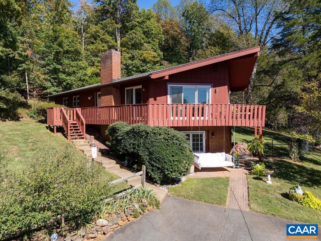 Don't miss this Mid-Century gem in Ivy's Glenaire neighborhood, located in the Ivy Elementary District & @15 minutes to UVA, shopping & restaurants. Perched to capture elevated views, this beautifully updated home features open-concept living w/ wood-burning fireplace & walls of sliding glass doors that open to an impressive three-sided wraparound deck—ideal for relaxing, entertaining or just enjoying the panoramic views. Light-filled kitchen includes white cabinetry, quartz counters & custom built-in breakfast bar. The main level offers easy one-level living and includes a beautiful primary suite w/ renovated bath, two additional bedrooms & full bath. The walk-out lower level adds flexible space w/ a cozy family room, additional bedroom, full bath, laundry, workshop & abundant storage in the pristine crawl space. Notable improvements include: private well upgrade (2025), new light fixtures (2025), EV charging capability (2024), Painted exterior (2024), HVAC (2022), most plumbing replaced (2021), Generac generator (2021), new sliding doors & double-pane windows (2019). Open House Sunday 10/19 from 1:00-3:00.