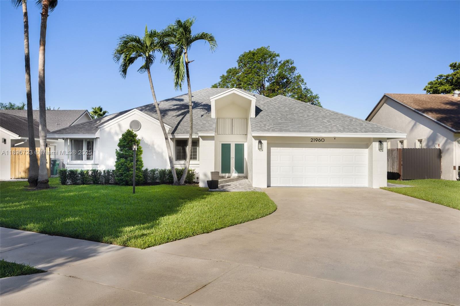 Impeccably renovated one-story residence in Lakes by the Bay with serene lake views and a showstopping backyard retreat. This 4-bedroom, 2-bath home features a spacious, modern kitchen with an oversized island, double-door pantry with pull-out shelves, and premium appliances. New roof, impact windows and doors, updated bathrooms, new AC, water heater, and full water treatment system. Epoxy-finished 2-car garage, laundry room, and security cameras add function and peace of mind. Enjoy alfresco entertaining under a large pergola surrounded by pavers, a majestic shade tree, and tranquil water views. Light-filled interiors offer tile flooring, generous living areas, and refined finishes. Located in a quiet, well-kept community with low HOA and easy access to parks, shops, and schools.