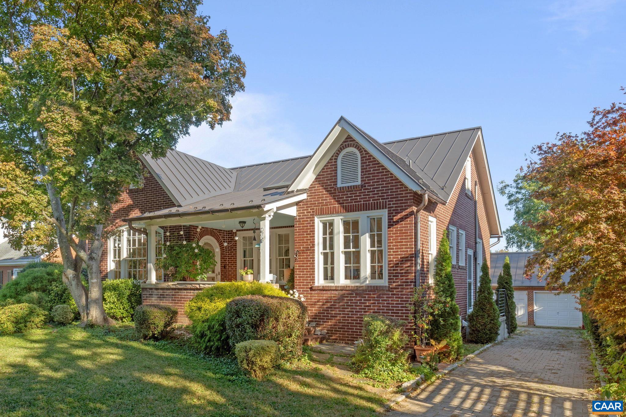 OPEN SUNDAY, 11/2, 1-3! Open your next chapter in this storybook c. 1930 cottage perfectly situated on dogwood-lined Evergreen Ave-one of North Downtown’s most beloved streets, along the 10-Miler route. A rare offering that blends timeless character w/ exquisite updates, this home delights at every turn. The inviting covered front porch and arched entry lead to a JEWEL BOX INTERIOR bathed in light streaming through architectural windows, 9.5' ceilings, handsome built-ins and white oak + southern yellow pine floors. The Karen Turner-designed kitchen is a SHOWSTOPPER, featuring Carrara marble counters, black walnut island, custom cabinetry, Bosch/Wolf appliances, built-in pantry + appliance storage + coffee bar. Sunny breakfast nook overlooks a peaceful backyard with IPE decking + built-in planters. MAIN LEVEL LIVING possible with 1st floor bedrooms and full bath. Upstairs offers a 3rd bedroom, 1/2 bath + flex space. Mountain views to the SE! Recent upgrades-NEW HVAC (2023) + NEW metal roof (2021) Potential for fabulous carriage house/studio in detached 2 car garage w/ electric panel + water/sewer access. An ENTERTAINER'S DREAM and idyllic retreat just steps from the Downtown Mall, boutique shopping, fine dining + farmer's markets.