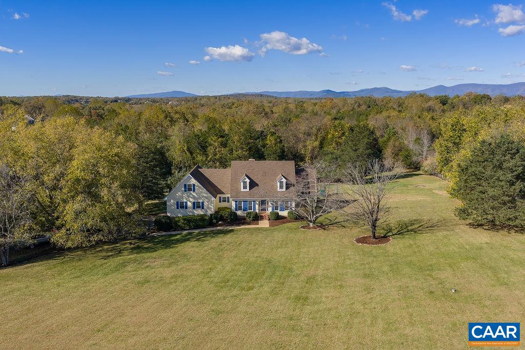 Gorgeous 8-acre property in the Earlysville area of Northern Albemarle County just 12 minutes from NGIC/Rivanna Station and the groundbreaking new $4.5B AstraZeneca project. Enjoy breathtaking sunrises and sunsets—come early one morning to see for yourself! This beautifully maintained, spacious home is move-in ready, featuring all-new windows, freshly painted interior and exterior, an fabulous composite deck, a 5-year-old architectural shingle roof, a whole-house 18kW Generac generator, and a long paved driveway with additional parking near the oversized garage. Inside, you’ll find a first floor primary bedroom with en suite and walk-in closet, 3 additional bedrooms upstairs, 2 additional full baths, a massive great room, a huge bonus room, spacious laundry off the kitchen, hardwood floors and a cozy brick fireplace with gas logs. The property includes thriving peach, plum and pear trees as well as ornamental cherry and dogwoods. There is rich soil for fabulous vegetable gardens and access to a small shared pond through the woods.