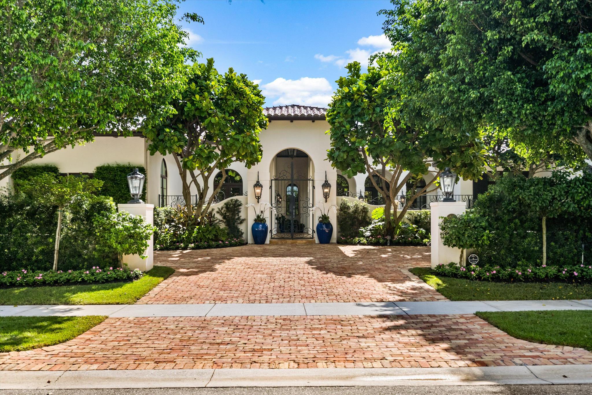 Exuding sophistication and timeless appeal, this stunning Cypress Island estate epitomizes luxury living within the prestigious Palm Beach Polo Golf and Country Club. Perfectly situated on a serene waterfront lot, the residence offers nearly 6,000 square feet of refined single-level living with 4 bedrooms, 6.5 bathrooms, and a 3-car garage.Sunlit interiors reveal a gourmet chef's kitchen appointed with Wolf appliances, a glass-enclosed walk-in wine cellar adjacent to the formal dining area, and an elegant living room anchored by a beautifully crafted fireplace. The owner's wing provides a private sanctuary featuring a sitting area, dual baths, and generous dressing spaces, while three spacious guest suites each include private baths and walk-in closets. 
Outdoors, lush landscaping frames an entertainer's paradise with multiple covered loggias, a fully equipped summer kitchen, full cabana bath, and an oversized saltwater pool overlooking tranquil water views. A rare opportunity to own a masterfully detailed residence in one of Wellington's most coveted enclaves.