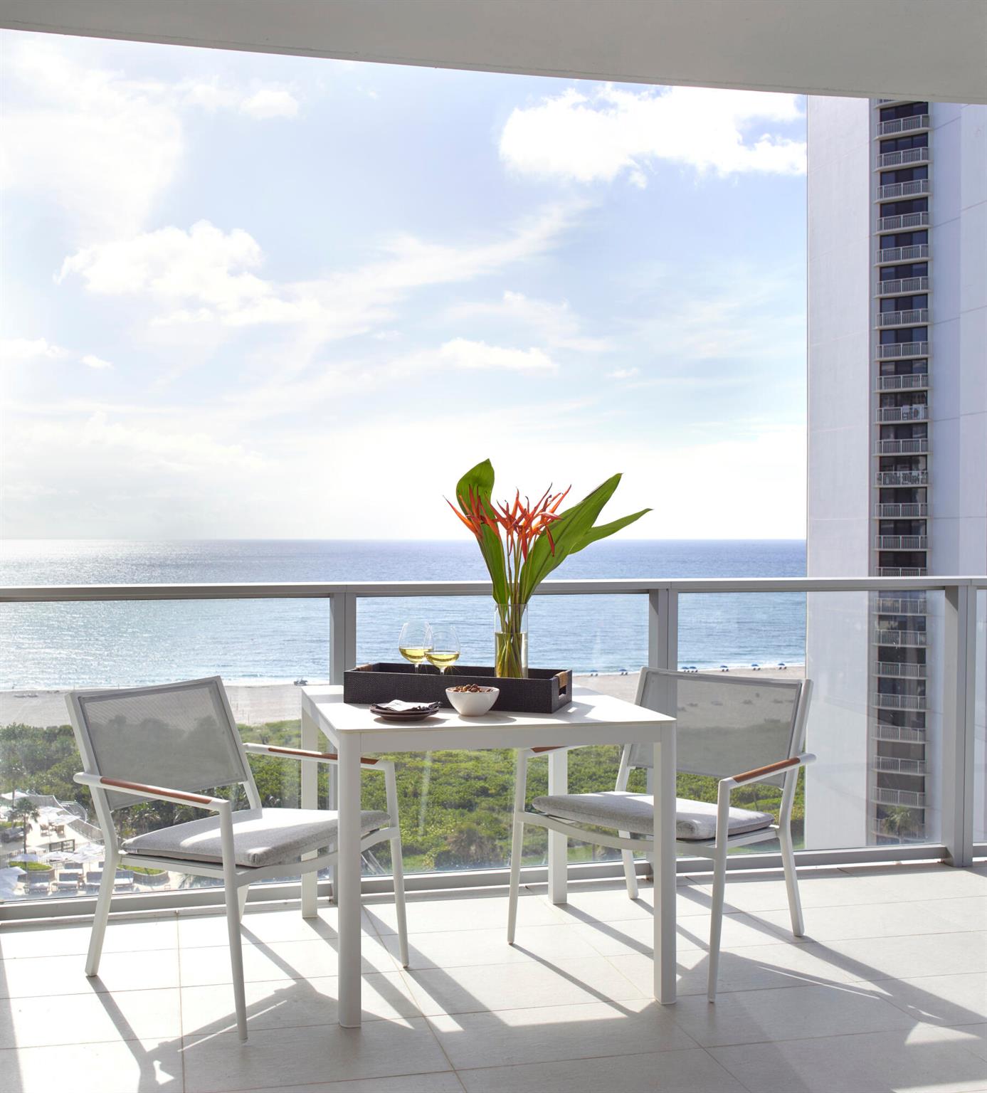 Experience luxury oceanfront living in this fully furnished, turnkey residence on the 11th floor of the newly completed Peace Tower at Amrit Ocean Resort & Residences. This southeast corner unit offers 2,525 sq. ft. of interior space and 900 sq. ft. of wraparound terraces with sweeping views of the Atlantic Ocean and Intracoastal Waterway. The 2-bedroom plus den,  & 3 full bathrooms features a gourmet kitchen, a wet bar, custom closets, built-ins, and automated blinds. The spacious den easily converts to a third bedroom. Floor-to-ceiling glass doors in every room provide stunning natural light and seamless indoor-outdoor living. Residents enjoy world-class amenities including four on-site restaurants, beach and poolside service, valet, concierge, and a state of the art Spa!
