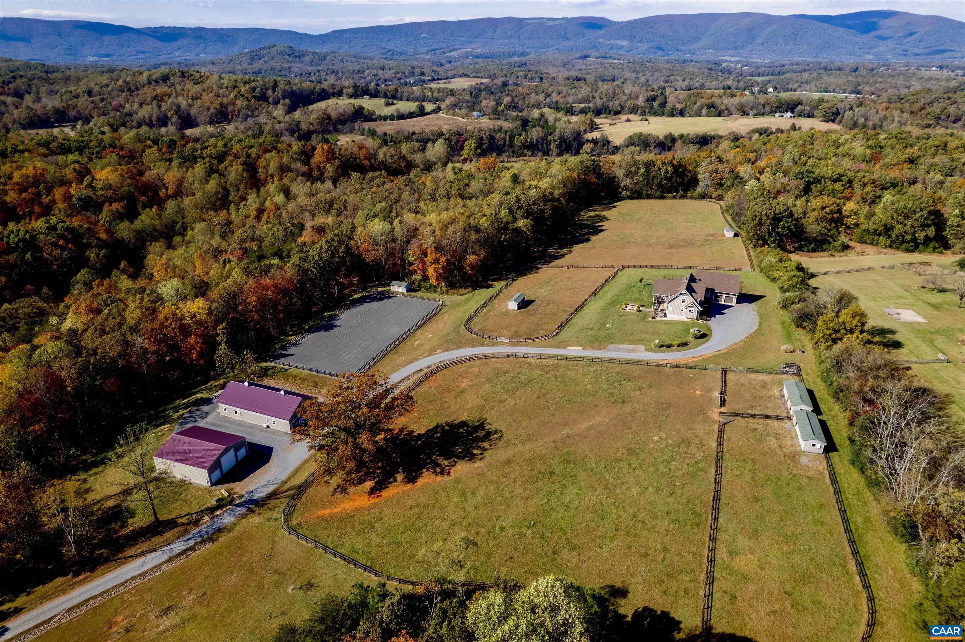 Whistling Ridge Farm - Discover this exquisite equestrian estate, offered for the first time, on nearly 80 private acres just outside Charlottesville. Nestled amidst mature hardwoods, this property boasts a custom mountain home with breathtaking 270-degree mountain views and a stunning, custom-designed horse facility including a 100x200’ riding arena and a total of 10 stalls (6 12x18’ foaling, 4 12x12’), 2 wash areas, 2 tack rooms, and a feed room with laundry. Enjoy expansive, well-maintained pastures with spacious run-ins and geothermal waterers. The land features a year-round stream, fruit tree orchard, and trails for riding, hiking, or ATV exploration, teeming with wildlife. A 42x48’ storage barn holds 100s of hay bales, class A rv (with 50-amp hookup), with room for all your equipment. The home, accented with red oak timbers, offers a modern open-concept design, a Tulikivi soapstone fireplace, and energy-efficient features like spray foam insulation and two-zone HVAC. The chef’s kitchen dazzles with a 60” Viking double oven range and a large walk-in pantry. Additional amenities include a 2-car garage, indoor/outdoor dog kennels, and a covered patio with outdoor kitchen and fire pit. Move-in ready for you and your animals!