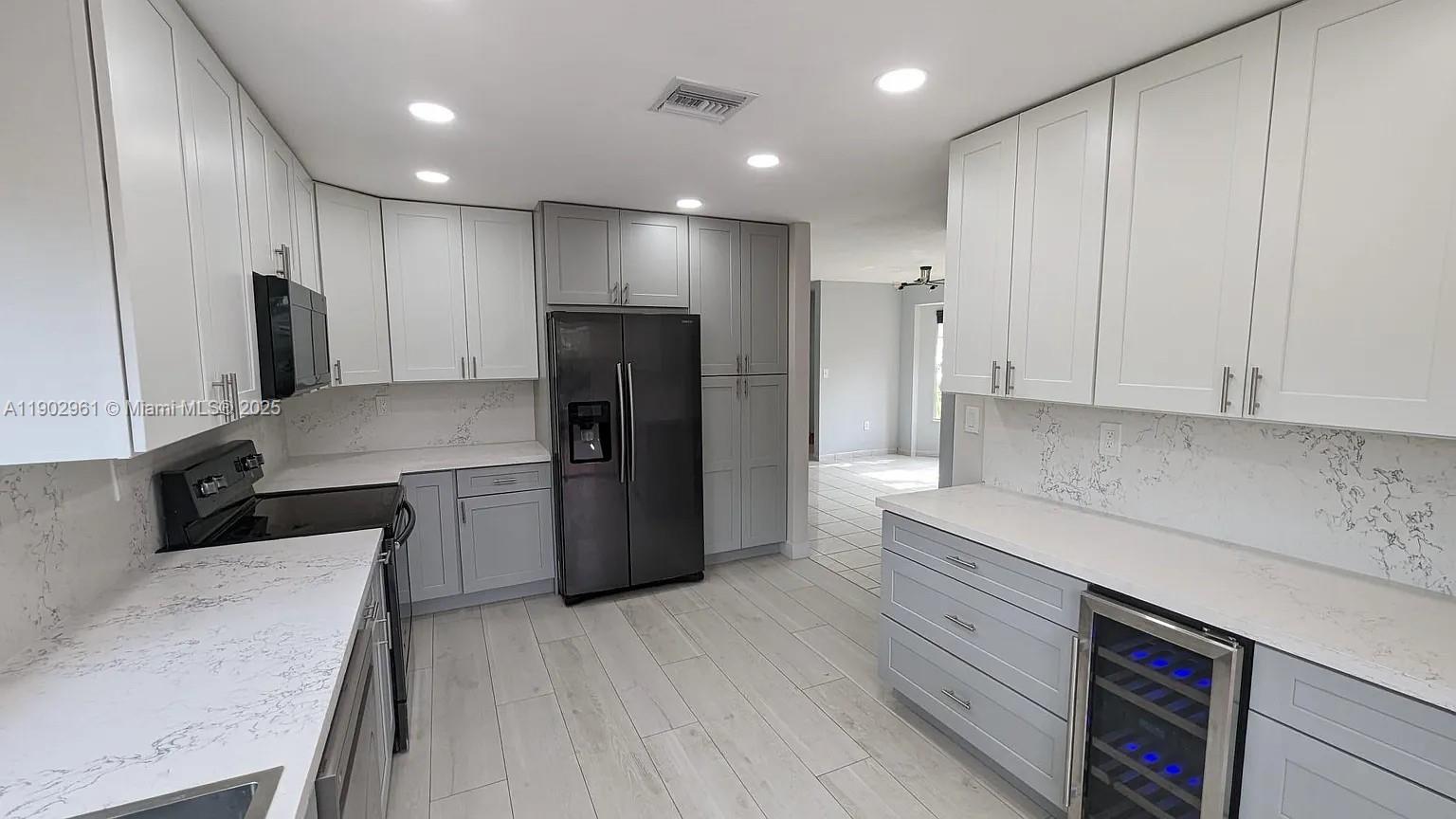 Beautifully renovated 3-bedroom, 2-bathroom corner home located in the quiet Catalina neighborhood inside Lakes by the Bay.  The home is conveniently located just 5 minutes from the turnpike, near parks, schools, and shopping.  This home offers a comfortable living room, dining area, and a designated laundry room with a washer and dryer.  The master bedroom features an en-suite bathroom and walk-in closet.  This spacious home features an upgraded kitchen with plenty of cabinets and a beautiful quartz countertop making meal preparation a breeze.  Bathrooms have been upgraded with modern fixtures.  This home offers the benefit of using a flex room as a 4th bedroom.  You can retreat to your backyard oasis enjoying an enclosed patio perfect for relaxing and entertaining any time of the year.