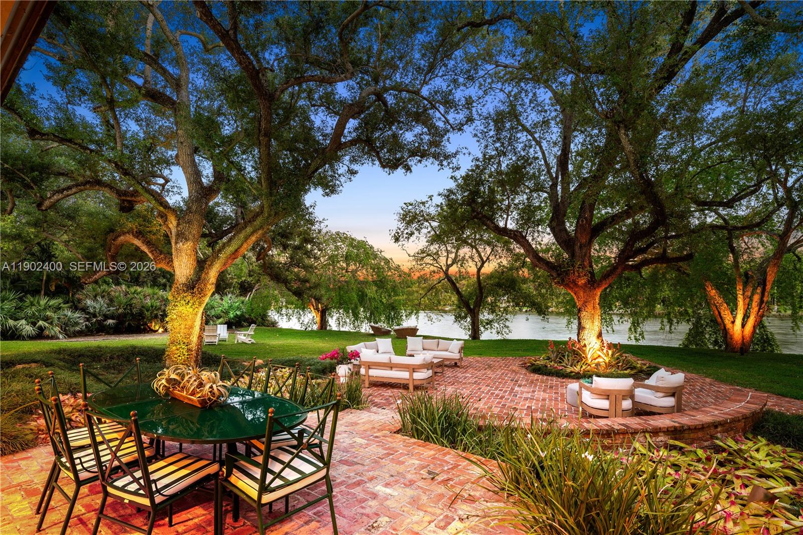 Welcome to an enchanting residence nestled in the prestigious gated enclave of Banyan Drive in Coral Gables. This spectacular lakefront property spans over an acre graced w/majestic oaks. The elevated contemporary architecture w/its new kitchen & baths, warm wood floors, & numerous entertaining spaces, all harmonize w/nature providing a stunning backdrop for daily life. Each room is designed to capture natural light & offer breathtaking views of the water & lush surroundings. Abundant space with the perfect angle for capturing the prevailing winds makes it an ideal setting for both intimate & grand gatherings alike. Experience nature w/early morning swims & sunset Kayak rides. This residence embodies a lifetime of elegance & comfort in a truly unparalleled location. A Very Special Home.