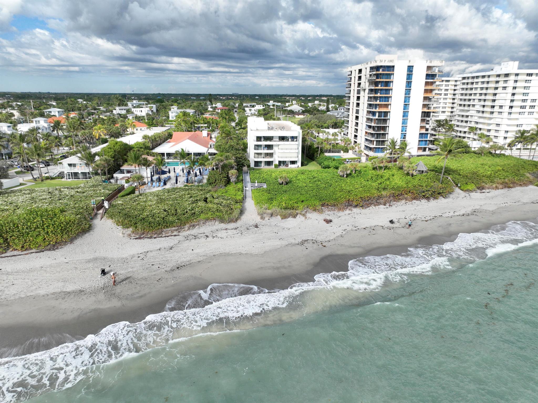 Experience the quintessential coastal lifestyle in this fully renovated ground-floor condo, just steps away from the tranquil shores of Juno Beach. Forget elevators and long walks, simply step out your door and feel the sand between your toes. Since 2021, this unit has been completely reimagined with a clean, beachy aesthetic from floor to ceiling. The new, modern kitchen is equipped with sleek stainless steel appliances, porcelain countertops, and a stunning sea glass backsplash that brings the ocean's palette indoors. With new hurricane windows and a recently replaced AC system, comfort and peace of mind are guaranteed. Enjoy the fresh, updated building, which recently replaced all its windows and resurfaced the pool, providing a pristine setting for your new life by the sea.