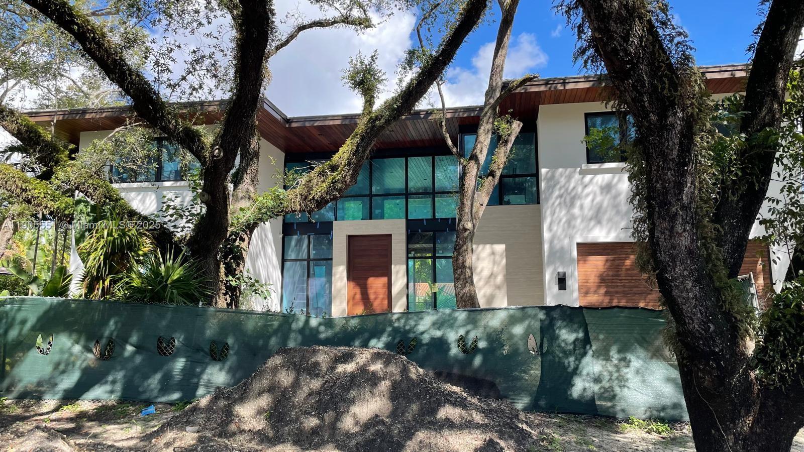 Rare opportunity to own new construction home in sought after Coral Gables designed by RG Architecture Group. Beautiful contemporary home with a one-of-a-kind extra large double-height space perfect for entertaining. Luxurious floor-to-ceiling windows look out to a tropical pool terrace and front yard with 6 mature oak trees. Sliding glass doors allow easy interior/exterior connection within your own private oasis. High ceilings and open layout provide comfort, flexibility and flow throughout the home. Oversized bedrooms provide comfort and luxury. Meticulous interior design by Rey De Castro Studio. Kitchen by IK studio and BBQ by Luxe Patio. Natural materials like stone, wood ceilings/floors and tropical landscaping along with attention-to-detail provide a exceptional living experience.
