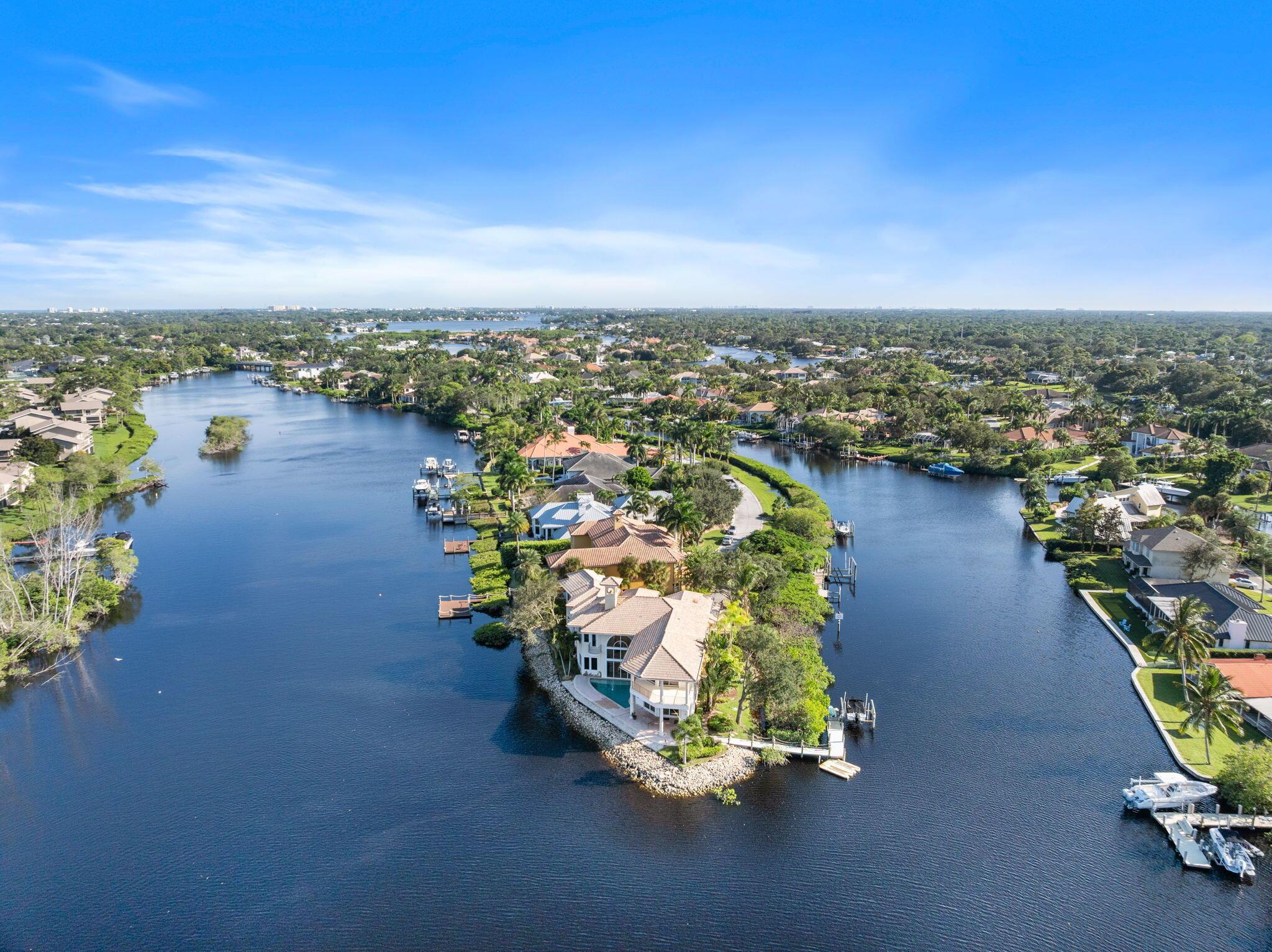 Experience the pinnacle of waterfront living in this extraordinary custom estate, gracefully positioned on a rare point lot at the tip of a private peninsula on the scenic Loxahatchee River. Set within a gated enclave w/ over 400 feet of water frontage, this home offers unmatched privacy & panoramic views of the river & surrounding nature preserve. Designed for those who value timeless architecture & the beauty of natural surroundings, the residence features soaring ceilings & expansive living spaces including 4 large bedrooms, private office w/ coffered ceilings, billiard room, workout room, sunken wet bar & a spacious gourmet kitchen.The primary suite provides a serene retreat w/ coffee bar, private waterfront balcony & sweeping river views. While this original residence (see more)... invites your personal vision for modern updates, it offers an exceptional foundation of quality craftsmanship&#x14;complete with marble &amp; bamboo flooring, impact windows, elegant crown molding &amp; exquisite architectural details throughout.
Outdoors, enjoy a waterfront pool, dock w/ 9,000 lb lift &amp; canoe launch &amp; direct ocean access&#x14;just 13 minutes to the inlet by boat. From the daily visits of a myriad of wildlife to the graceful flight of Ibis at sunrise &amp; sunset, every moment here feels like living in your own private nature preserve. This is more than a home&#x14;it's a one-of-a-kind riverfront sanctuary, ready to be reimagined into your personal paradise.