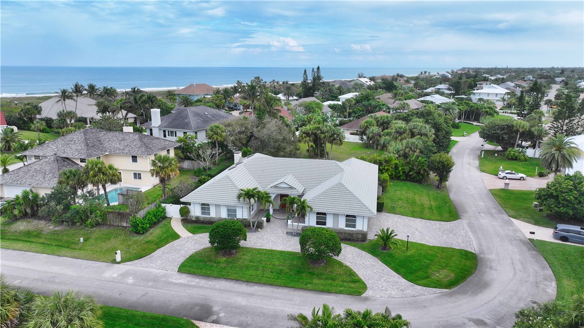 Located East of A1A in the family friendly Castaway Cove. A mere short walk to the pristine beach access. This generously spacious home with a thoughtfully designed floor plan features 3,082± AC SF, 3 beds, 4 full baths, & 3-car garage. Vaulted ceilings & crown molding create an atmosphere of elegance while the skylights fill the interiors with natural light. Formal living and dining rooms. Family room with coral stone fireplace is adjacent to the well appointed kitchen that is designed for both functionality & style. Embrace the Florida lifestyle w/ the screened lanai overlooking the pool.