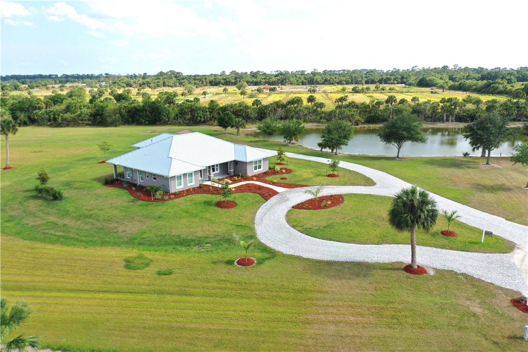 Best of both worlds - country living AND only 11 miles to the beach! Situated on 4.8 Acres at the end of a cul-de-sac, this custom '23 built CBS 4 Bed/3 Bath home w standing seam metal roof is full of upgrades. Featuring a mother-in-law suite w 2 private entrances, vaulted ceilings w exposed wood beams, faux stack stone gas fireplace, gourmet island kitchen w wine fridge, GE appliances and luxury cabinetry w walk-in pantry. Owner suite w massive walk-in closet, dual vanities, sliders to entertainment patio. Whole home gas generator, artesian well, stocked pond, landscaping & so much more!