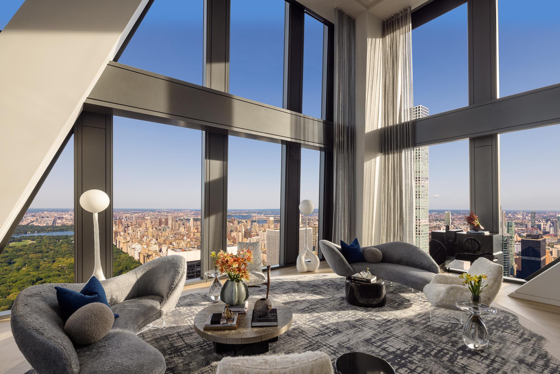 An oasis above the clouds, this one-of-a-kind duplex penthouse comprises the entire 76th and 77th floors at 53 West 53, spanning 7,973 square feet with 360-degree views from Central Park to New York's iconic cityscape skyline. The exquisite residence offers  four bedrooms, three-and-a-half bathrooms, dedicated service entrance, private interior elevator, and north-, south-, east-, and west-facing exposures that span across Central Park, the Hudson River, East River, City skyline, and beyond. Gracious proportions,  magnificent details, and ceilings that range up to approximately 21'8" set the awe-inspiring stage for world-renowned designer, Thierry Despont, to craft residences with many custom elements typically reserved for privately commissioned homes. These museum-quality  finishes coalesce with expressive architecture by Pritzker Prize-winner Jean Nouvel to create singular spaces of unsurpassed grandeur and elegance in both scale and proportion. On the lower level, a dramatic double-height great room with monumental limestone-clad fireplace wrapped in three walls of floor-to-ceiling windows that artfully frame panoramic Central Park views. An airy gallery leads to the corner formal dining room,  also with stunning Park views, adjoining the windowed custom kitchen by Thierry Despont for Molteni, where polished statuary marble countertops and a back-lit statuary backsplash complement back-painted glass cabinetry with polished nickel detailing and Dornbracht  fixtures. The extensive suite of appliances by Miele and Sub-Zero includes two fully integrated refrigerators and freezers, five-burner cooktop with fully vented hood, integrated dishwasher, double wall oven, speed oven, steam oven, under-counter wine refrigerator,  and integrated coffee maker. Two generous bedrooms share access to a windowed bathroom clad in high-honed Verona limestone with polished nickel Dornbracht fixtures. A beautifully appointed powder room and discreet utility closet with washer and vented dryer  complete this level. Accessible either via the dramatic interior staircase or the private interior elevator, the 77th floor is extraordinary. The primary suite offers panoramic views spanning north, south, and east, a large walk-in closet and spa-like ensuite bathroom that blends  tradition and originality. Elegantly appointed in polished Noir St. Laurent marble, high-honed Verona limestone, and polished Persian golden travertine with polished nickel Dornbracht fixtures throughout, the primary bathroom features two separate custom carved  vanities, a cast iron Lefroy Brooks soaking tub, freestanding steam shower, radiant heated floors, private water closet with commode and bidet, and a linen closet. An additional bedroom on this level offers south- and west-facing views and a windowed en-suite  bath clad in high-honed Verona limestone with polished nickel Dornbracht fixtures. No detail has been overlooked, from the custom interior lighting design by Thierry Despont in collaboration with Schwinghammer, to the motorized Lutron solar shades throughout  with additional blackout shades in each bedroom, to the supply of humidified and filtered fresh air throughout the home. 53 West 53 is a sculptural icon, rising 1,050 feet in the heart of Manhattan against the cinematic backdrop of Central Park and the surrounding cityscape. Designed to be responsive to residents in every way, 53 West 53 offers 30,000 square feet of amenities  and five-star hotel-level service, bringing an unprecedented level of access and refinement to the residential experience. The building also features an on-premise partner restaurant, 53 by Altamarea Group, with exclusive resident-only dining experiences. The complete offering terms are in an offering plan available from Sponsor. File No. CD14-0230. Sponsor: W2005/Hines West Fifty-Third Realty, LLC, 53 West 53rd Street, Unit 38C, New York, NY 10019.