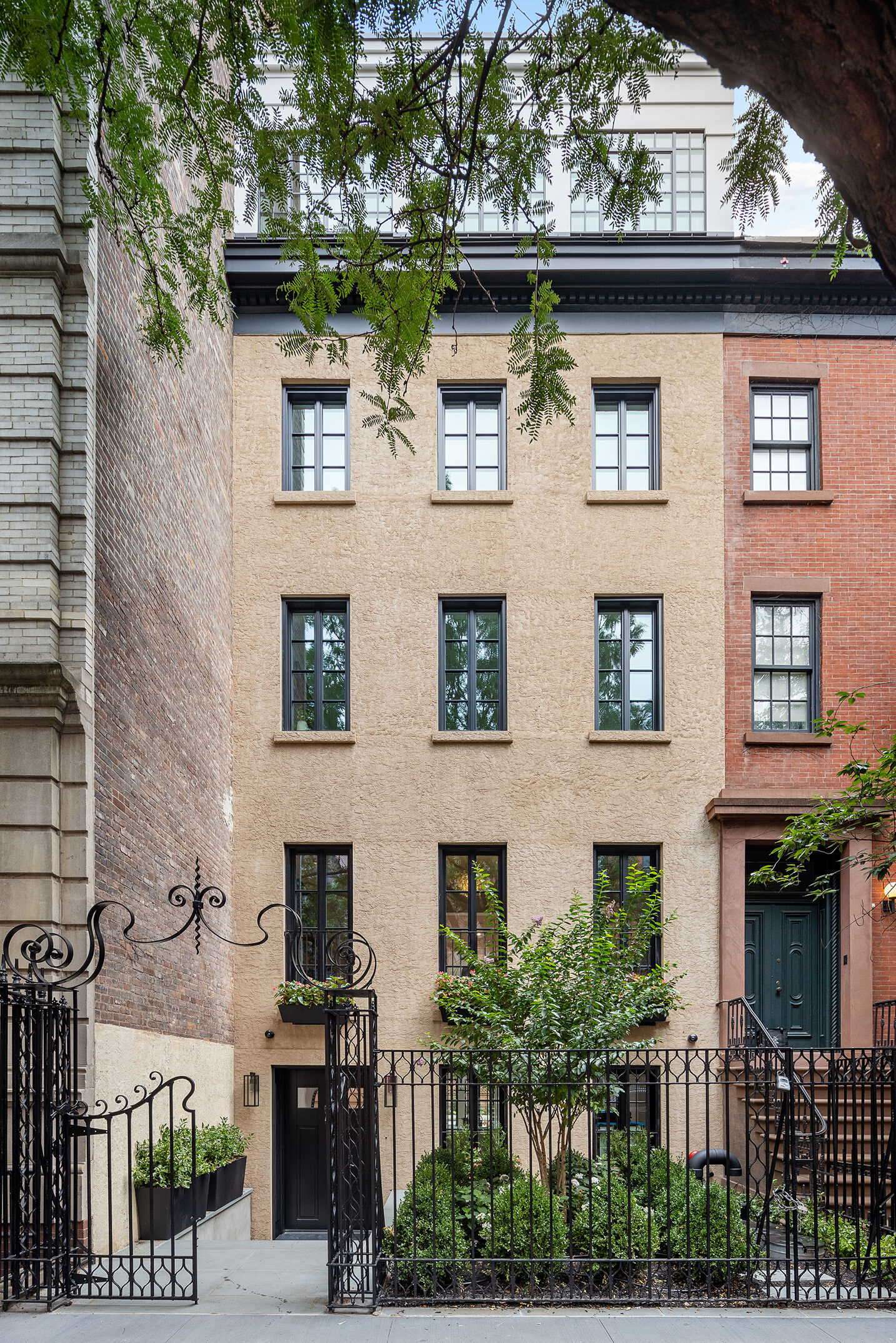 Experience the pinnacle of townhouse living at 235 West 11th Street, a fully transformed six-story residence boasting a complete gut renovation and expansion. This mint-condition home now features an elevator, four private outdoor spaces—including a 40’ deep garden bordered by neighboring townhouse yards and three spacious balconies—Warmboard radiant heated floors throughout, and a fully integrated Savant Home System.  

Set on one of the West Village’s most coveted townhouse blocks, the property is discreetly set back from the street with a beautifully landscaped forecourt offering privacy and security. Upon entering, a gracious foyer leads to a show-stopping kitchen highlighted by a 15’ Calacatta Gold Borghini central island, custom Leicht millwork cabinetry, and top-tier appliances.  

Elegance permeates the home, with chevron rift & quartered white oak flooring, Venetian plastered ceilings, and bespoke millwork throughout. The parlor level is an entertainer’s dream, featuring tall North and South-facing windows with Juliet balconies, a formal dining room, and a 25’-deep rear parlor with a gas fireplace overlooking the lush townhouse gardens.  

The full-floor primary suite offers unmatched privacy, complete with ample dressing closets, a private terrace, and a luxurious bathroom featuring chevron-laid marble floors, Waterworks fixtures, a soaking tub, and a windowed shower. Three additional bedrooms with en-suite bathrooms occupy the upper floors. The top level, bathed in light from casement windows with South and East exposures, serves as an office, sitting room, or additional bedroom, with views of the Freedom Tower and townhouse rooftops.  

An elevator provides access to every level, including the north-facing roof terrace. The finished basement offers 9’ ceiling heights, wine storage, a laundry room, and a versatile rear recreational room with skylights, ideal for a fitness area, media room, or office.  

Located in the heart of the West Village, 235 West 11th Street is surrounded by renovated townhouse mansions, celebrated dining, and premier shopping on Bleecker Street. The Hudson River Park, High Line, and Whitney Museum are just steps away, completing this unparalleled lifestyle offering.