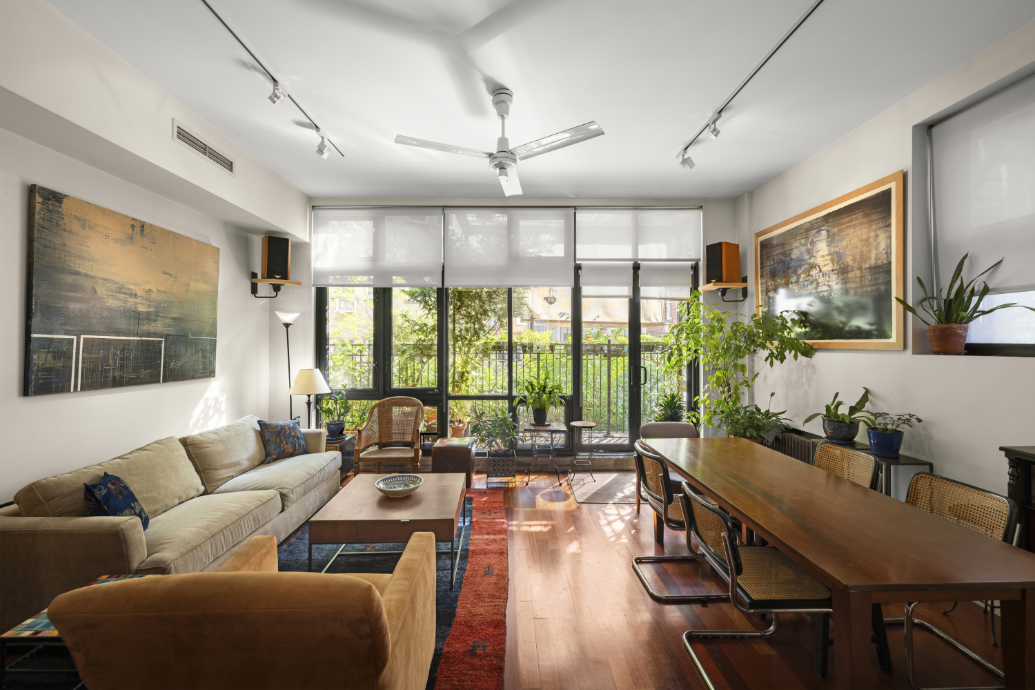 Step into the world of limitless possibilities at 406 East 13th Street-a two-unit townhouse that redefines modern living in the heart of the East Village. Tucked away on a picturesque tree-lined street, this extraordinary property offers a seamless fusion of residential elegance and commercial opportunity, making it a rare and coveted gem in one of Manhattan's most eclectic neighborhoods. The Residence Enter the upper unit, and you're instantly enveloped in an ambiance of sophistication and serenity. This sun-drenched residence spans two impressive floors, where soaring ceilings and floor-to-ceiling windows create a luminous, open environment that invites you to live expansively. The main floor is a haven of relaxation, featuring an airy living space that flows effortlessly into a private library/home-office-a perfect retreat for quiet contemplation or inspired creativity. Just beyond, a charming terrace beckons, offering a secluded oasis amidst the urban buzz. Ascend to the upper level, where three tranquil bedrooms await. The primary suite, affectionately known as "The Studio," is a private sanctuary that captures the essence of refined living. Step out onto your personal balcony and take in the morning light or unwind with a glass of wine as the city glows beneath you. The second bedroom is a sun-soaked haven, with a skylight that floods the space with warmth, while the primary bathroom, also graced with a skylight, transforms daily routines into moments of indulgence. And when you're ready to escape to the sky, the rooftop terrace offers an unparalleled outdoor experience. Here, the city stretches out before you, a vibrant canvas of life and light-perfect for entertaining under the stars or enjoying peaceful solitude above it all. The Salon Below, "The Salon" presents an equally enticing opportunity. This expansive unit, complete with a mezzanine level housing two serene treatment rooms, is more than just a commercial space; it's a gateway to financial freedom. With a long-term tenant already in place, you're poised to enjoy a steady stream of income, whether you're an investor with an eye for prime real estate or a homeowner seeking a harmonious balance of work and life. The Townhouse 406 East 13th Street isn't just an address-it's a lifestyle. Nestled in the East Village, a neighborhood renowned for its artistic spirit and dynamic energy, this townhouse puts you at the epicenter of culture, cuisine, and creativity. From the eclectic boutiques and gourmet eateries to the vibrant nightlife and tranquil parks, every corner of the East Village is brimming with possibilities. This townhouse is more than a home; it's an invitation to craft the life you've always envisioned. A canvas brimming with potential, it's ready for you to make it your own. Embrace the rare opportunity to own a piece of New York City's ever-evolving story, where history and future converge in one extraordinary residence.