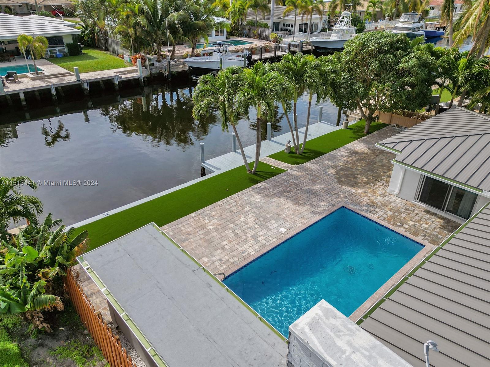 HUGE PRICE REDUCTION!!! Welcome to your New Waterfront Home!! Bring your Yacht and park it close to the Intercostal with easy access to the Open Ocean. 75 Feet on the Water with NO Fixed Bridges. Heated Pool. 4 Bedrooms with 3 full bathrooms. Lots of natural light with plenty of sliding doors and big windows. Completely renovated with oversized Porcelain floors, Granite Kitchen and Bathrooms, Brand New Metal Roof, Brand New Impact Windows and Doors, Brand New Decking and Patio, New Kitchen Appliances and Washer/Dryer. Circular driveway with plenty of extra parking.  New Landscaping all around with working sprinklers.  Easy to show. Please text listing agent.