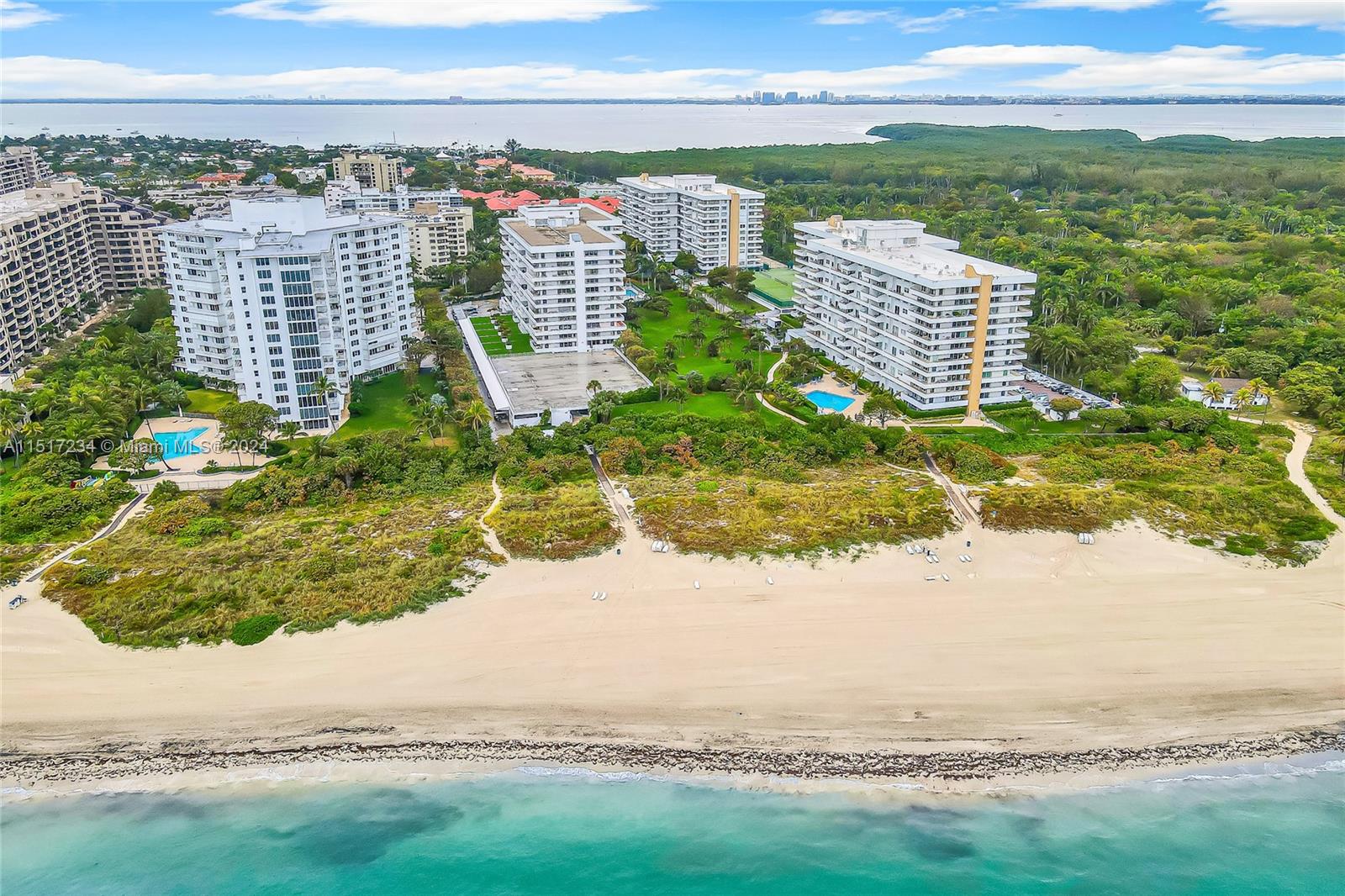 Rarely available! Oversized 2BR/2BA, 1,350 sq. ft. southeast corner unit at Commodore Club West in Key Biscayne. The wraparound terrace offers stunning direct ocean and park views, with balcony access from the master bedroom. Features IMPACT windows and doors, and 1 assigned upper-level parking space. Enjoy direct beach access with complimentary chaise lounges and umbrellas, private pool, gym, sauna, tennis courts, and 24-hour concierge and security. Embrace the opportunity to create a personalized living space in this prime location!