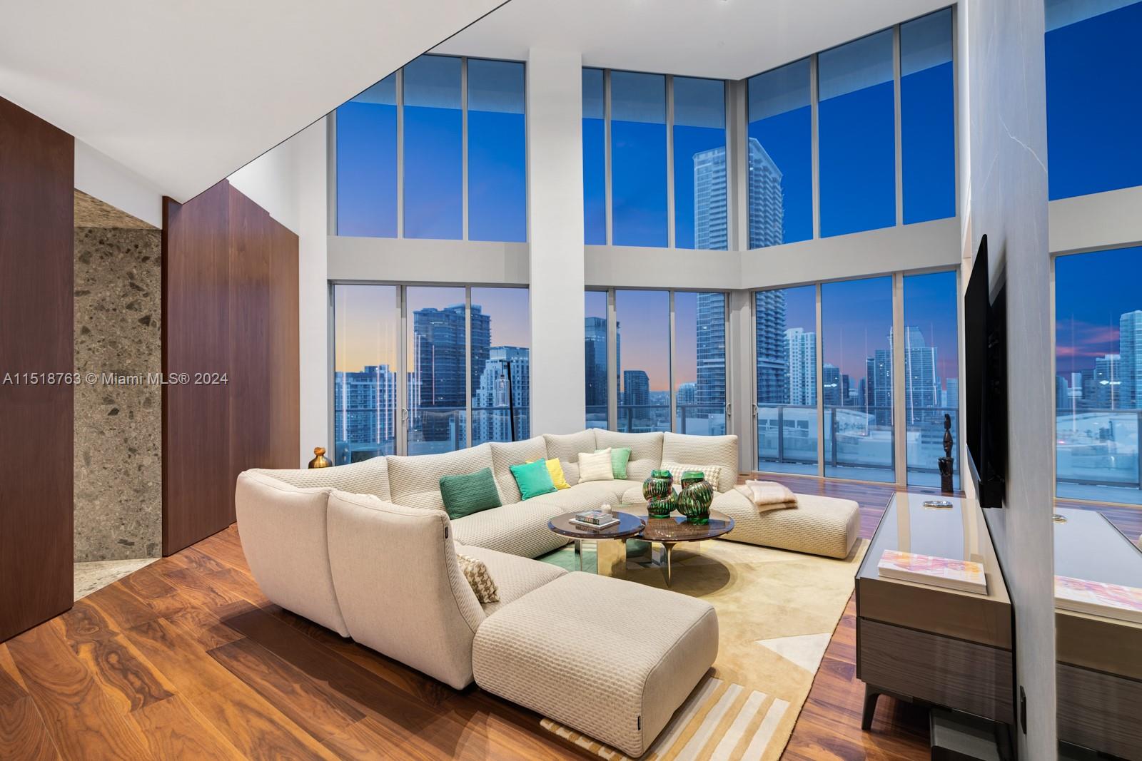 This fully remodeled 2-story penthouse redefines sophistication and style, design by Togu Design and remodeling by Sabal Luxury Builder. From the foyer you are greeted by breathtaking water views. Black walnut floors seamlessly flow throughout, creating an atmosphere of modern elegance. Expansive living spaces w 20 ft ceilings set the stage for 6,521 sf of living area including 5 beds, 6/2 baths, office, movie theater & gym.The chef's kitchen is an epicurean delight w top of the line appliances & endless views The inclusion of an automated Savant system elevates the living experience, providing intuitive control over lighting, climate, and entertainment.Building amenities include rooftop pool w sundeck,50-foot lap pool w cabanas,fitness center & more.
