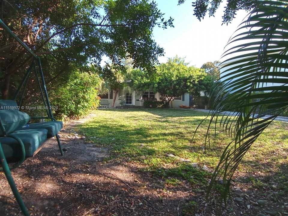 Alluring 1947 Miami Beach home set within the picturesque tree-lined park setting of Lake View Miami Beach. The great room features beautiful vaulted ceiling, original hardwood floors and fire place, sitting area dining room. The master bedroom features vaulted celling, walk-in closets and a spacious marbled double vanity spa room with walk-in steam room shower and separate lavatory. The bright sun-filled guest bedrooms include original wainscot doors, J&J wash room and other period correct vintage touches. High impact French doors open to back yard deck and patio. The secluded, expansive front yard, can accommodate various recreational activities, tennis, volleyball, & gatherings. Move-in condition, style it and grow your way.