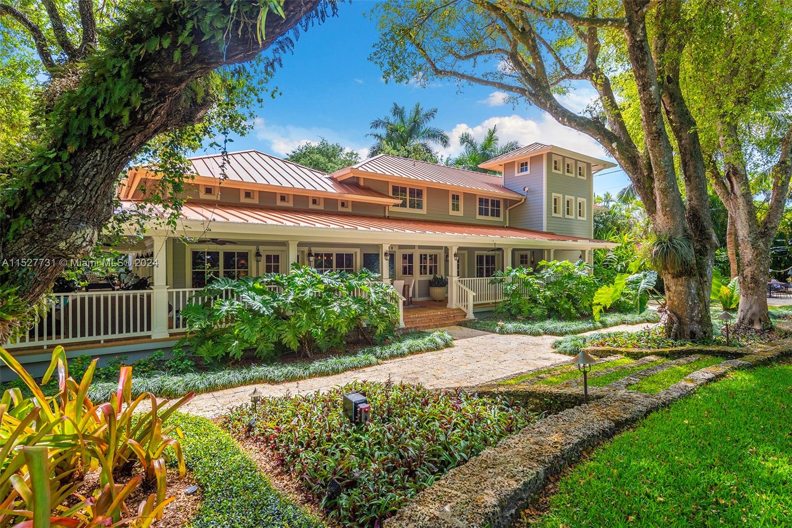Located in the guard-gated Banyan Lakes neighborhood, this 2003 custom Old Florida estate-style home w/ wraparound porches spans 8,765 SF & is the epitome of sophisticated living.  Situated on a 50,000+ sf lot that is nothing short of magical w/ live oaks, terraced lawn, & lush landscaping around the lagoon-style pool & patio. The 6 BR, 5.2 BA home w/ floorplan that calls for entertaining features a formal liv rm that opens to a zen garden & family rm w/ custom built-ins & fireplace. The bespoke kitchen incl Caesarstone counters, Wolfe & Subzero appliances, banquette & butlers pantry.  The primary ste has  large BR, gym, 2 walk-ins, & spa-like BA. There are 4 add’l BRs upstairs + office. White oak floors, impact glass, 2014 metal roof, generator, 2-car gar are some of the special features.