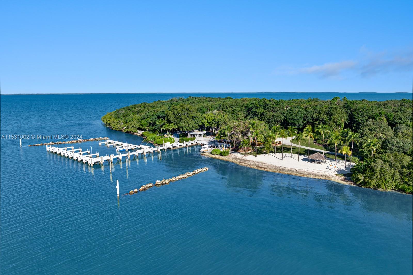 Nestled amidst the waters of the Florida Keys, an unparalleled opportunity awaits - your very own 26 acre Private Island plus an additional waterfront mainland home within Ocean Reef Club. The Island boasts a pool home, twelve 1-acre developable waterfront lots, a 23-slip marina capable of accommodating a mega-yacht, 3 separate apartments, dock master office, a white sand beach & 2 tennis courts which convert to a helipad for a 10 minute flight to Miami. Modern infrastructure including fiber optic cable, water, & electricity, ensures seamless connectivity & convenience. The ORC property is a 4-min boat ride away & features 100ft dock. Whether as a private retreat, legacy investment, or a sanctuary for generations, this property stands as a beacon of distinction and exclusivity.