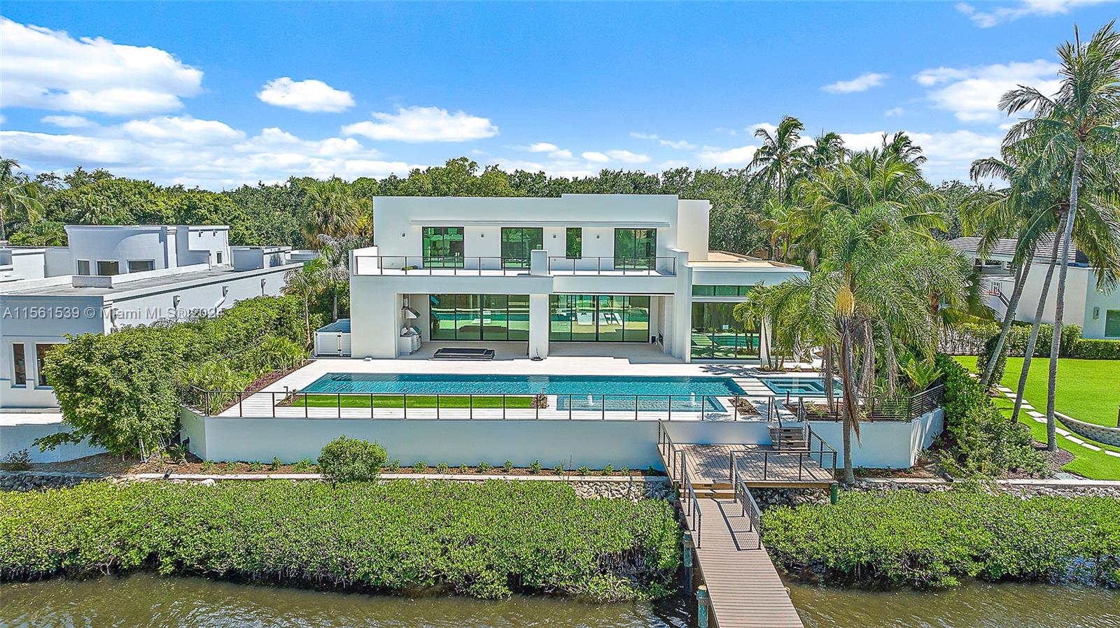 Welcome to 410 Mariner Drive, a contemporary waterfront masterpiece in the prestigious enclave of Admirals Cove. Featuring 7,998 sq ft of interior living space and a total living area of 12,253 sq ft, this new build seamlessly blends modern design with unparalleled amenities, making it the epitome of waterfront opulence.

Outdoor bliss awaits as you step into the captivating 75-ft Euro Edge infinity pool, complemented by a champagne spa and sundeck, creating a lavish waterfront retreat. The meticulously designed lanai, boasting a summer kitchen and outdoor gas fireplace, seamlessly connects the interior with the picturesque surroundings, while the private dock with deep water access caters to boating and yachting enthusiasts.