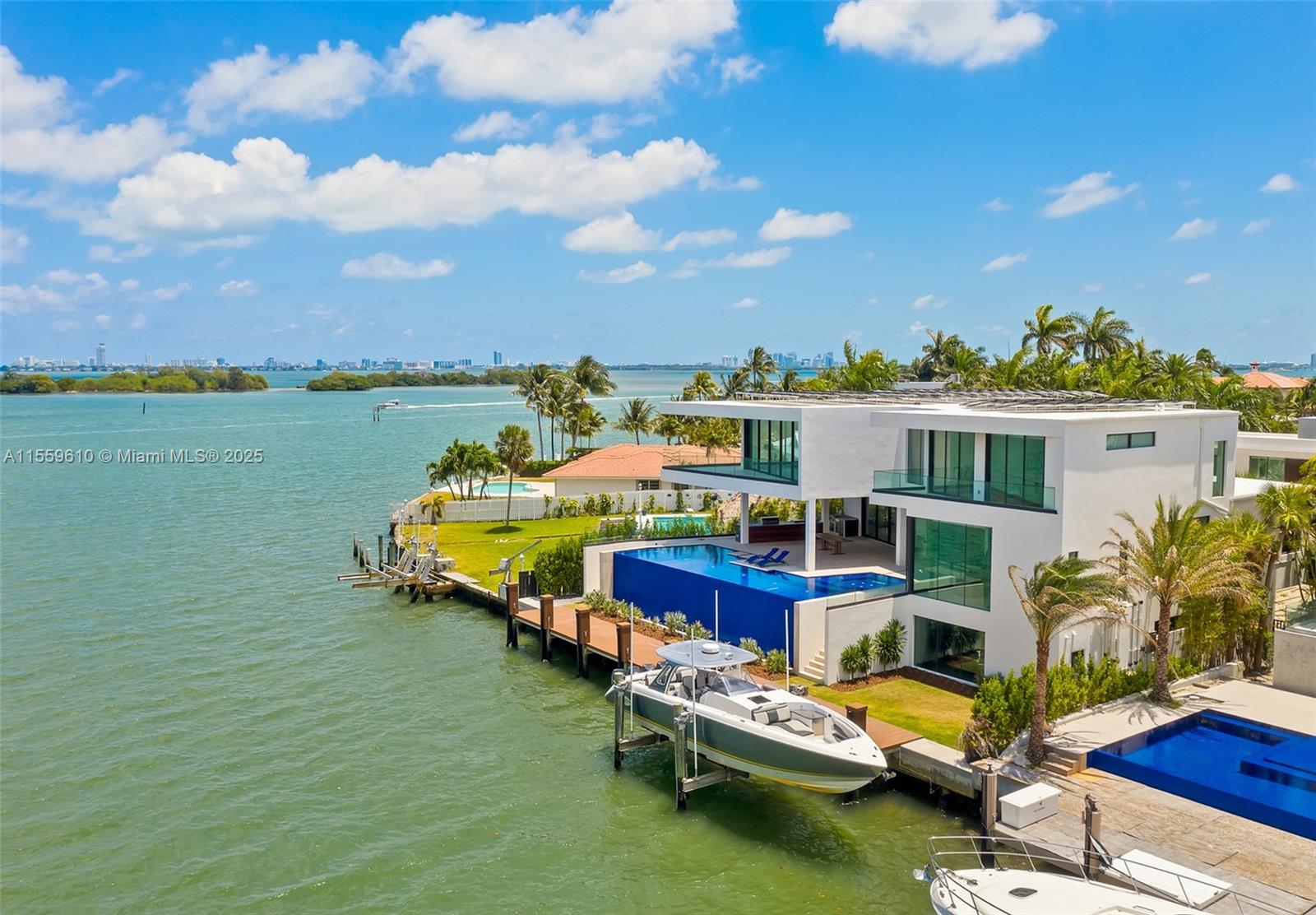 Stunning Bay/Canal Contemporary Residence- 100+ ft on deep water - New Construction (total of 12,200 SF under A/C).  Loaded with ultra luxury finishes and very little use - 35KM solar electric generator w/six Tesla power walls & Travertine exterior walls.  All custom lighting & sound throughout.  Unique glass elevator to all three levels.  Generous sized rooms and large closets.  Art Gallery, Office-Library, amazing 12 car garage, play room & wine cellar.  Breathtaking views of the Open Bay, City lights and tropical gardens from all rooms.  Huge covered Patio + Summer Kitchen w/50ft infinity edge pool.  Full dock & Boat Lift. Double gated 24/7 Island in the heart of Miami.  Minutes to Design District, Beaches, Downtown Miami & Bal Harbour.  Owner Financing Available.