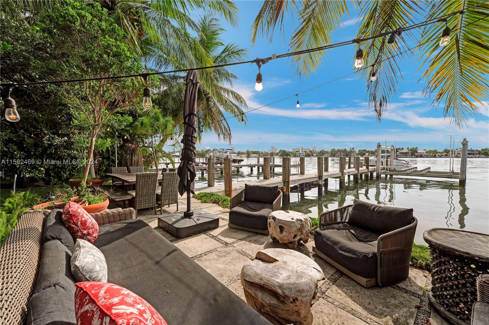 Waterfront home w/ beautiful & lush garden features 3 bed,3 baths + den. Direct intercoastal access w/ 50' water frontage, perfect for boaters.(lift 56,000lbs) Easy to get on water into incredible sunsets. The principal bedroom is facing magnificent green oasis where you can create your own little paradise:morning yoga/meditation or entertain dinners under the starlight. Located in gated community, residents of Stillwater enjoy a sense of privacy and security. Despite its peaceful settings, its short drive away from the vibrant nightlife, world-class dining and the beach (close proximity to Surfside, Bal Harbor&South Beach) The community has basketball courts and kids' park. Enjoy the magical views of the open Bay sunrise & sunsets, bonfire at night in the garden.