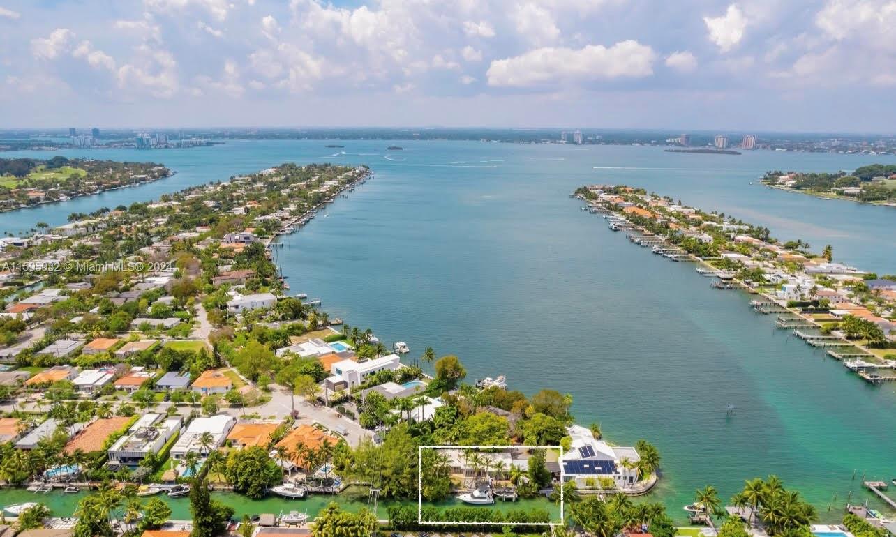 Discover the unparalleled charm of this timeless waterfront home in gated Biscayne Point Island. Located at the island's edge on a private street shared by only two other homes, this residence was designed with the highest quality finishes. Crafted by one of Miami's best designers and her artist husband, every detail was thought out maximizing natural light and its prime position on the bay. Featuring tasteful architectural and design elements throughout, it has an open floor plan, 11-foot ceilings, a large primary suite, oversized 450+ sq. foot 3rd bedroom with a private entrance to the deck + more. With 162 ft of waterfront, 30 ft from the open bay, it's an idyllic haven for boaters and those with an appreciation for architecture and design. Complete with boat lift and expansive dock